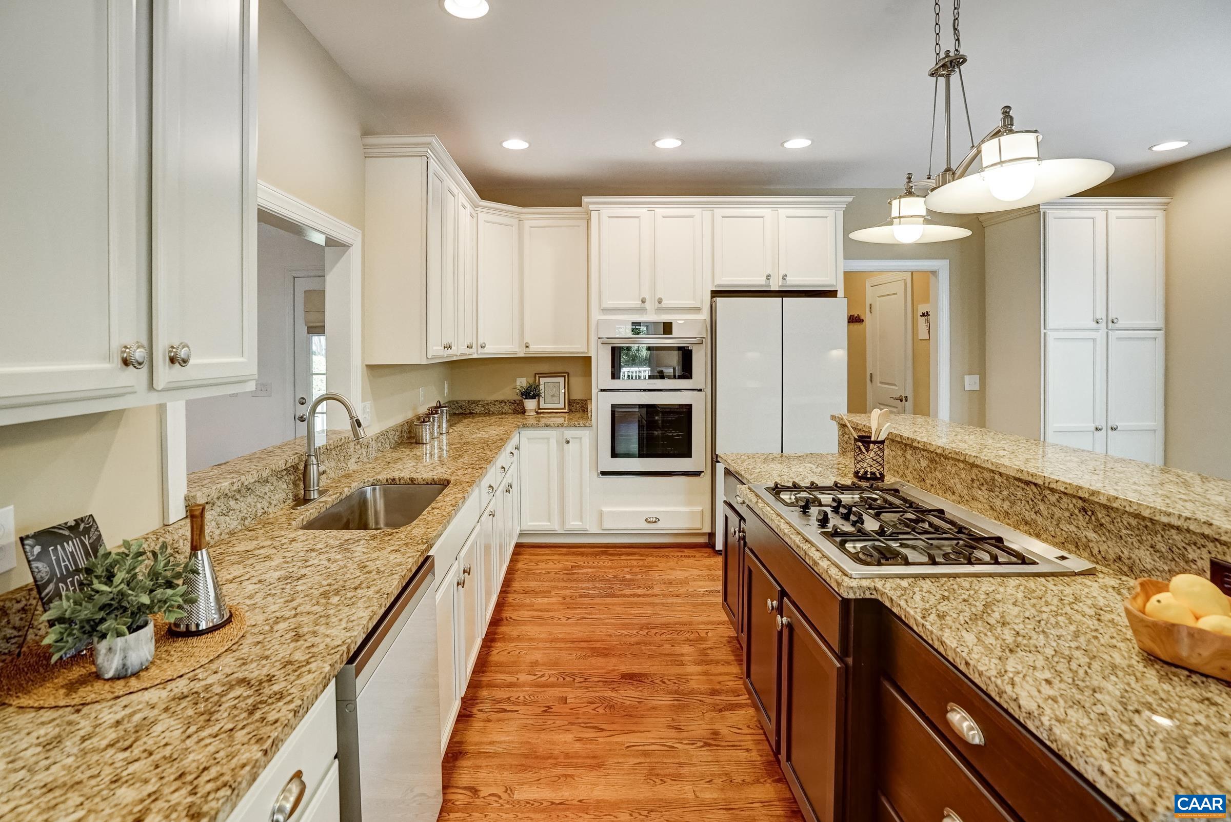 White cabinets and granite counters with contrasting island.