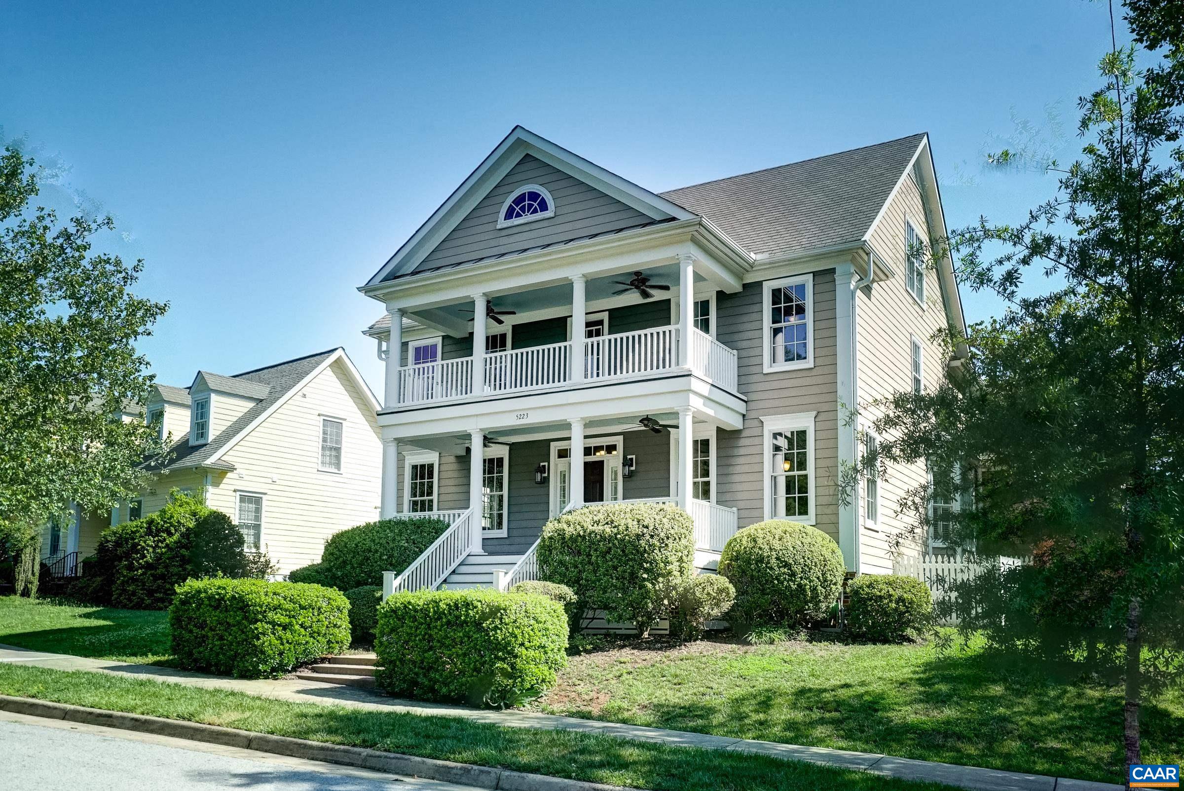 Stacked covered porches on the front of the home.