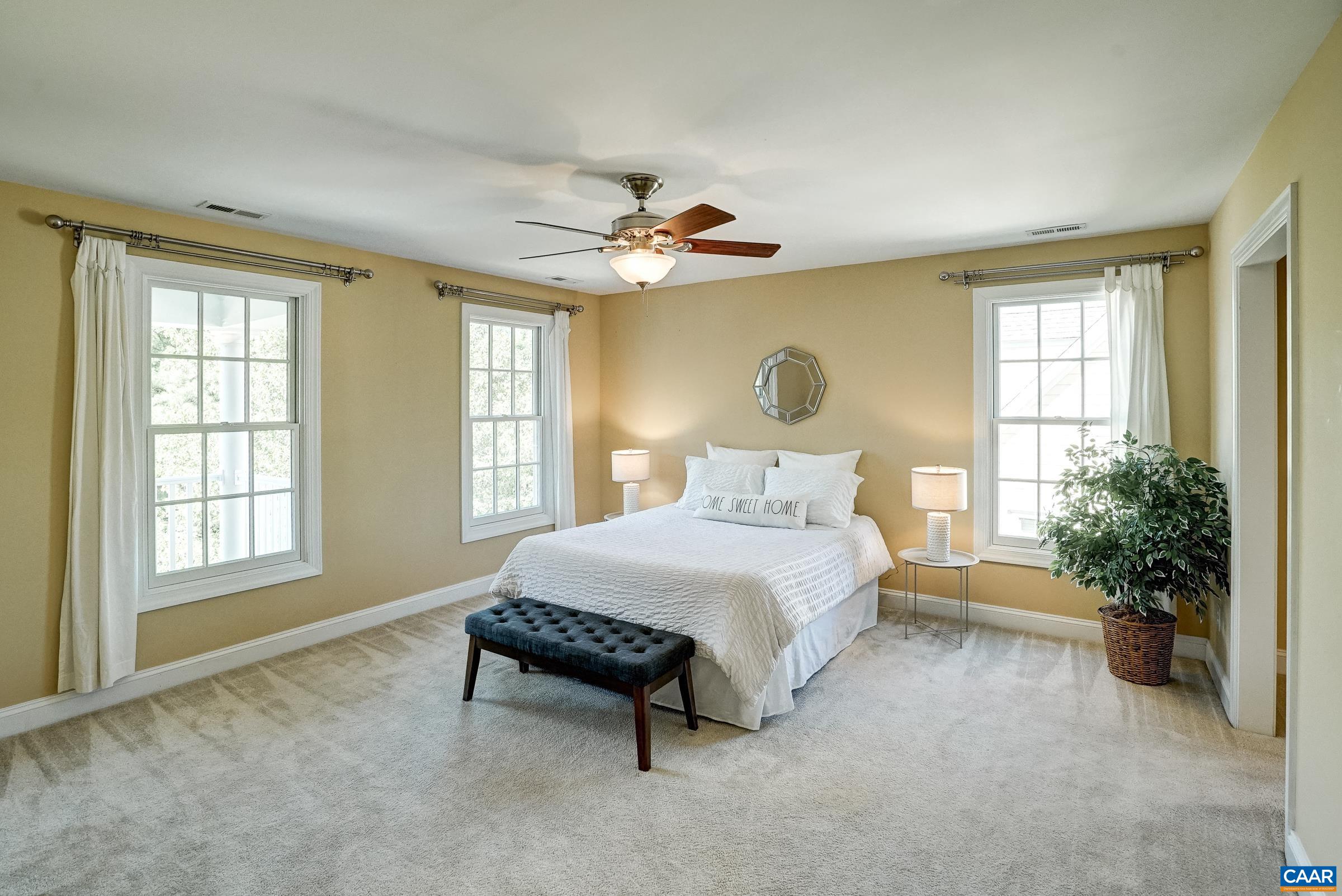Spacious primary suite features ensuite bathroom and large walk in closet.
