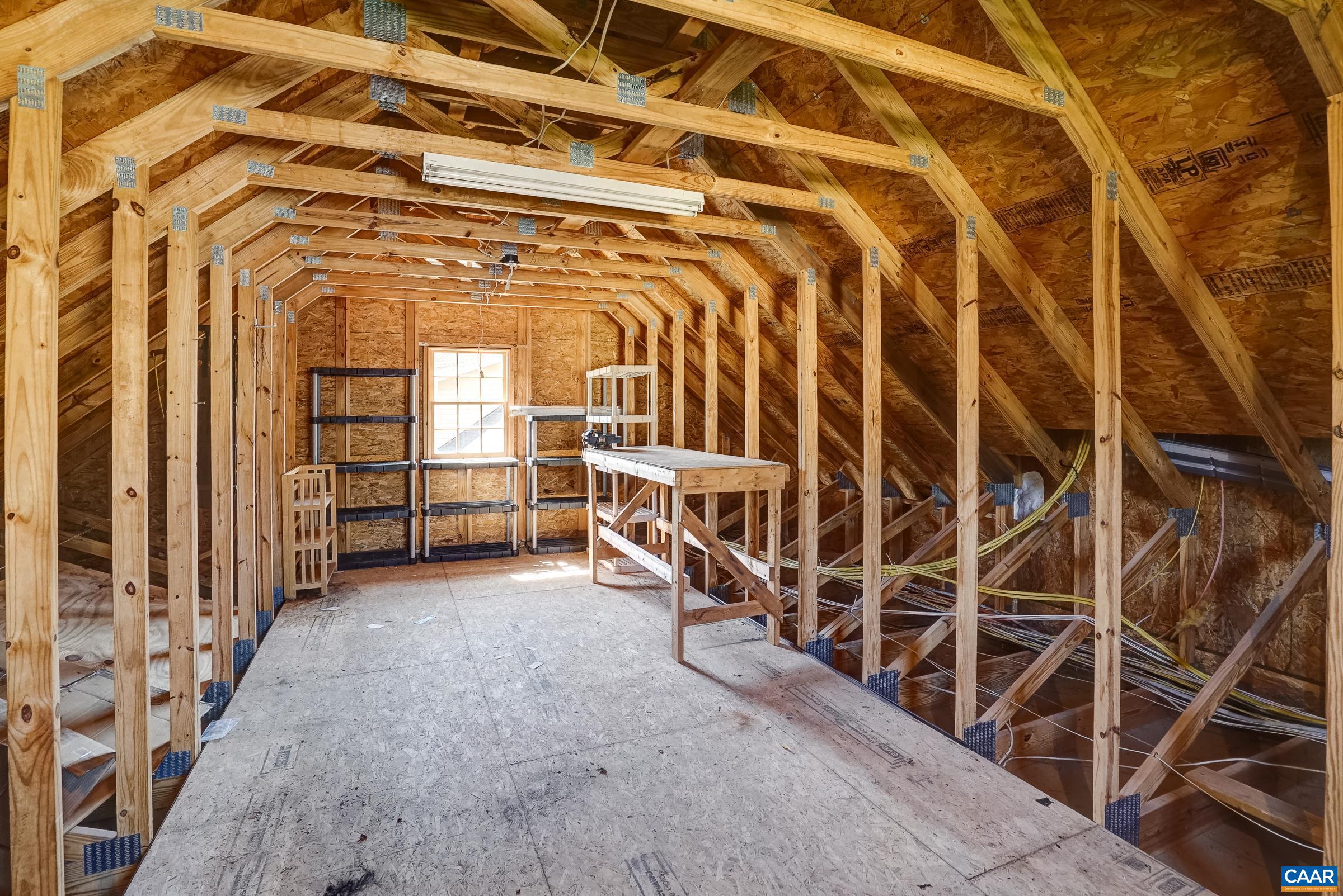Walk-up stairs lead to floored attic space above garage.