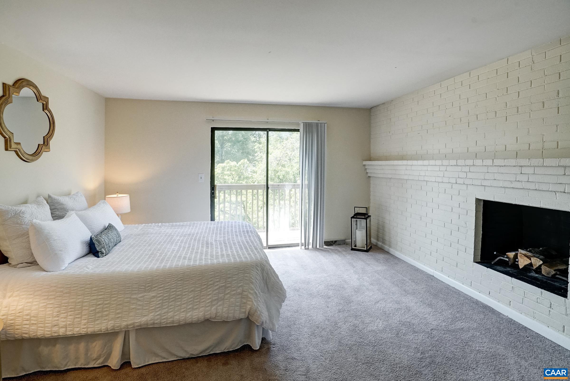 Primary one features a wood burning fireplace and access to the private balcony.