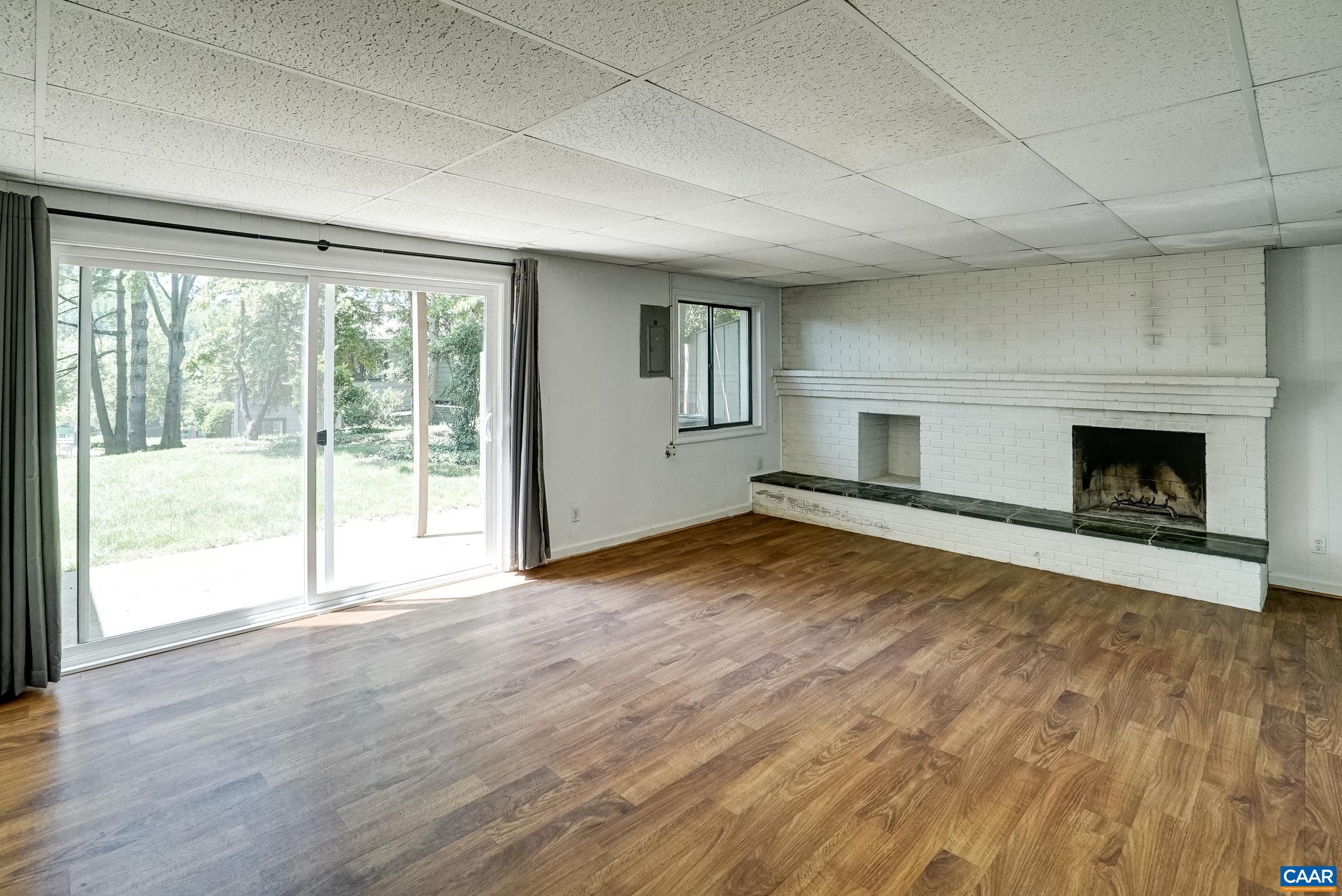 New sliding door (2026) leads to patio and flat common area behind home.