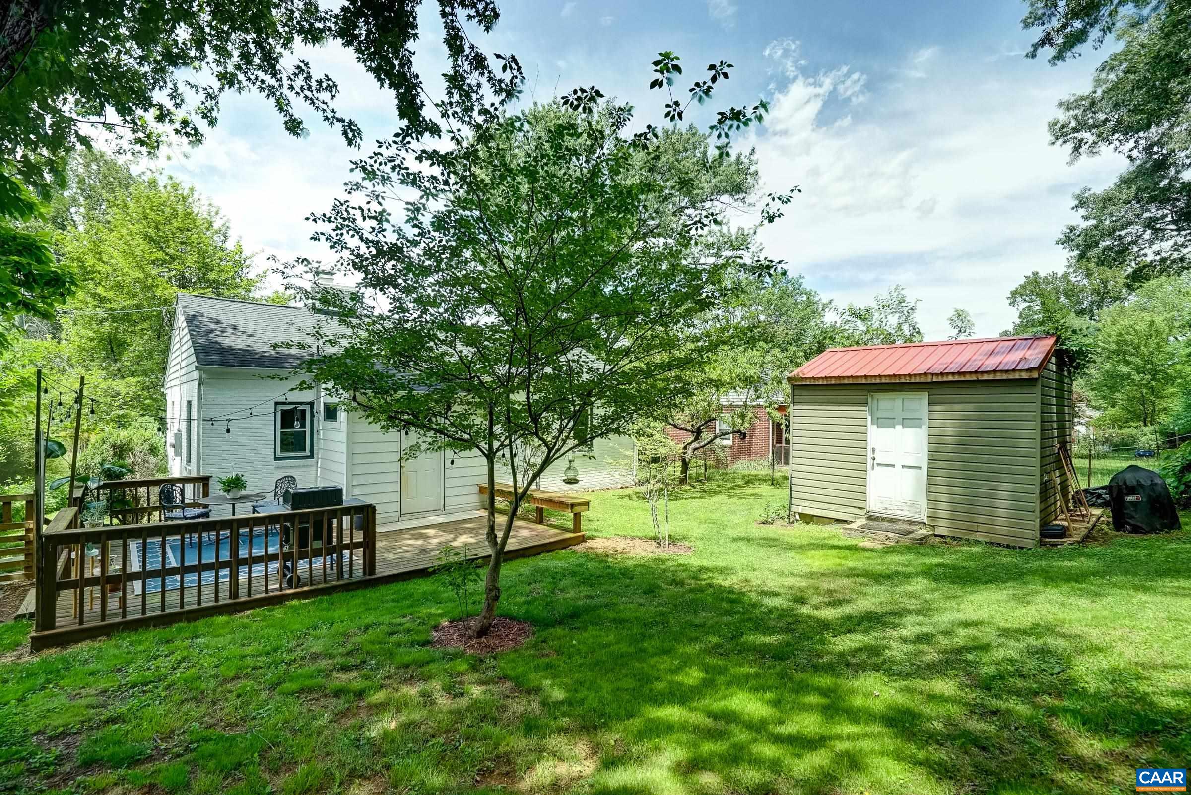 Large fenced back yard with mature trees and room to run and play.