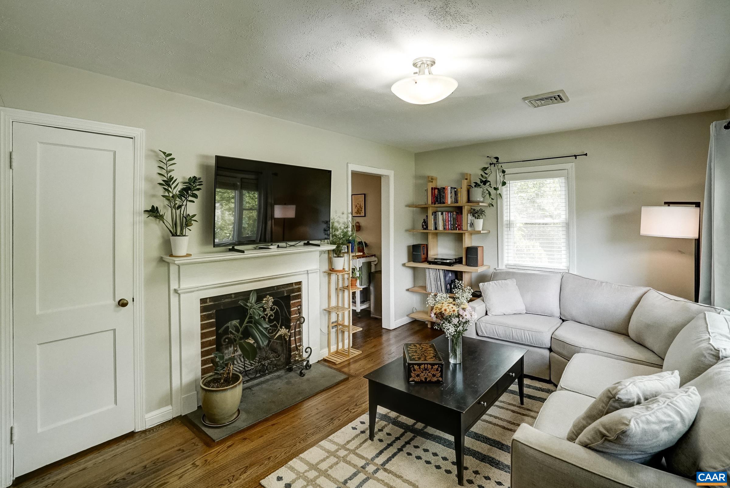 Living room with wood-burning fireplace is a cozy spot.