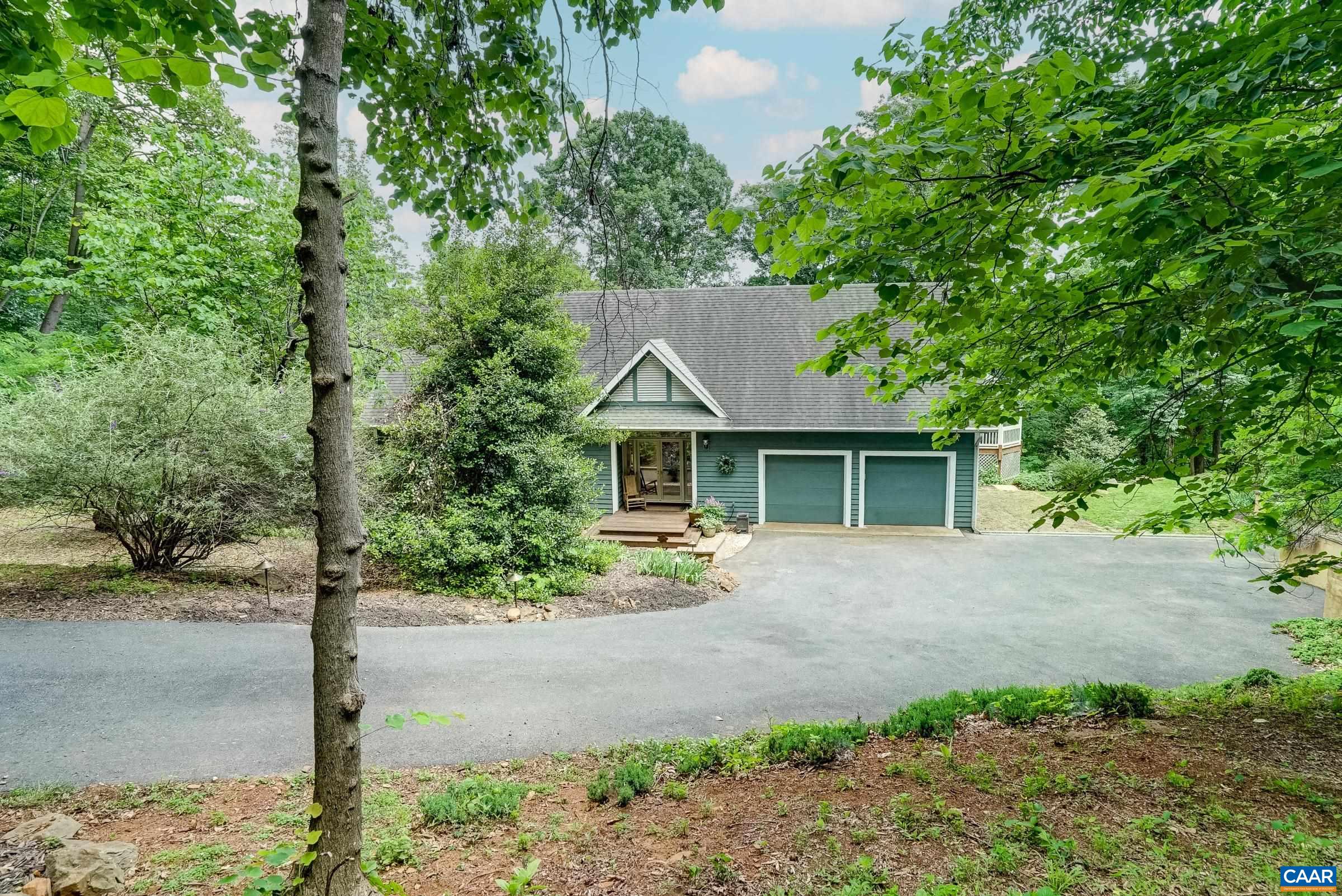 Mature woodlands surround this beautiful home with incredible mountain views from the rear decks.