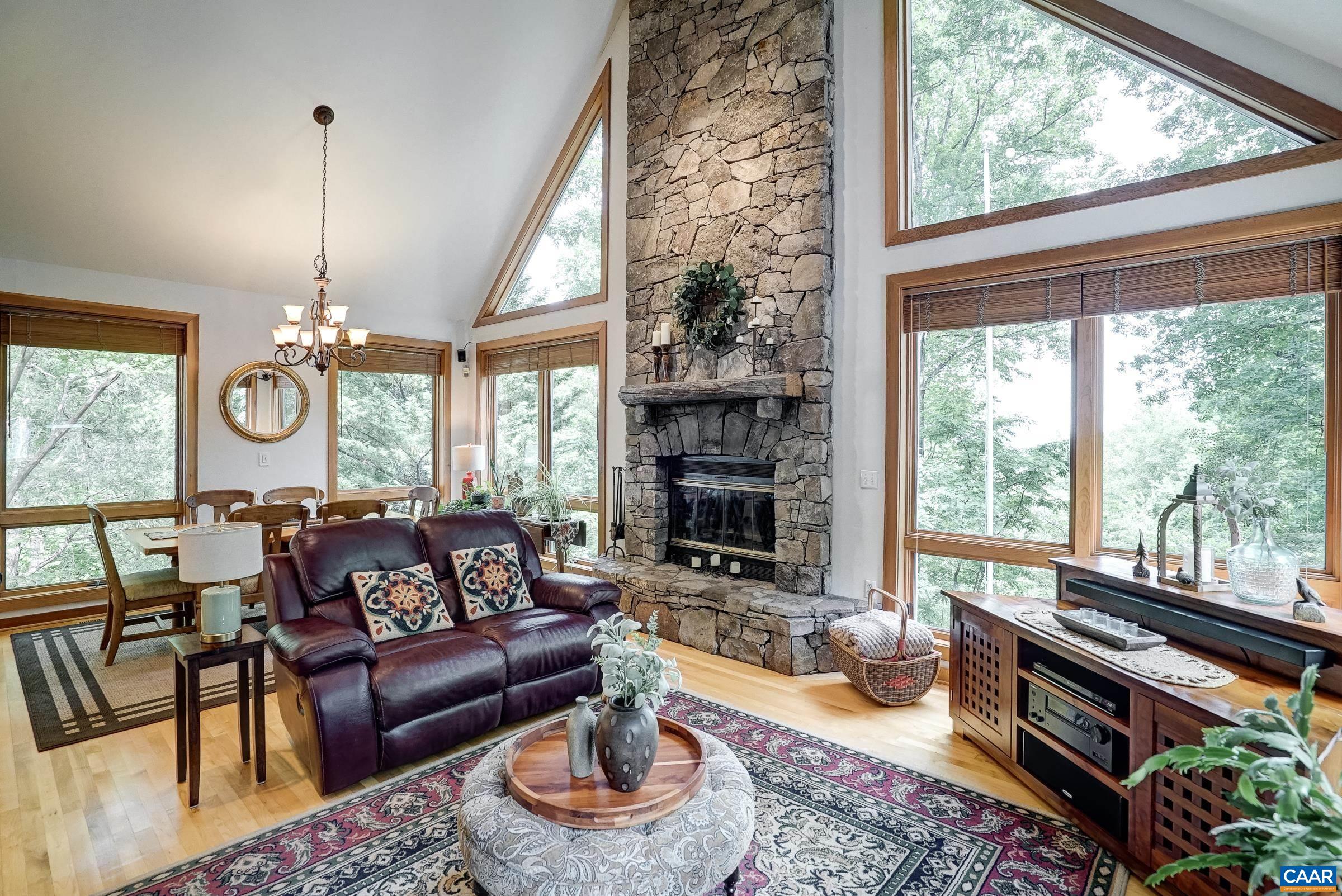 Stone fireplace flanked by windows - feels like a tree house!