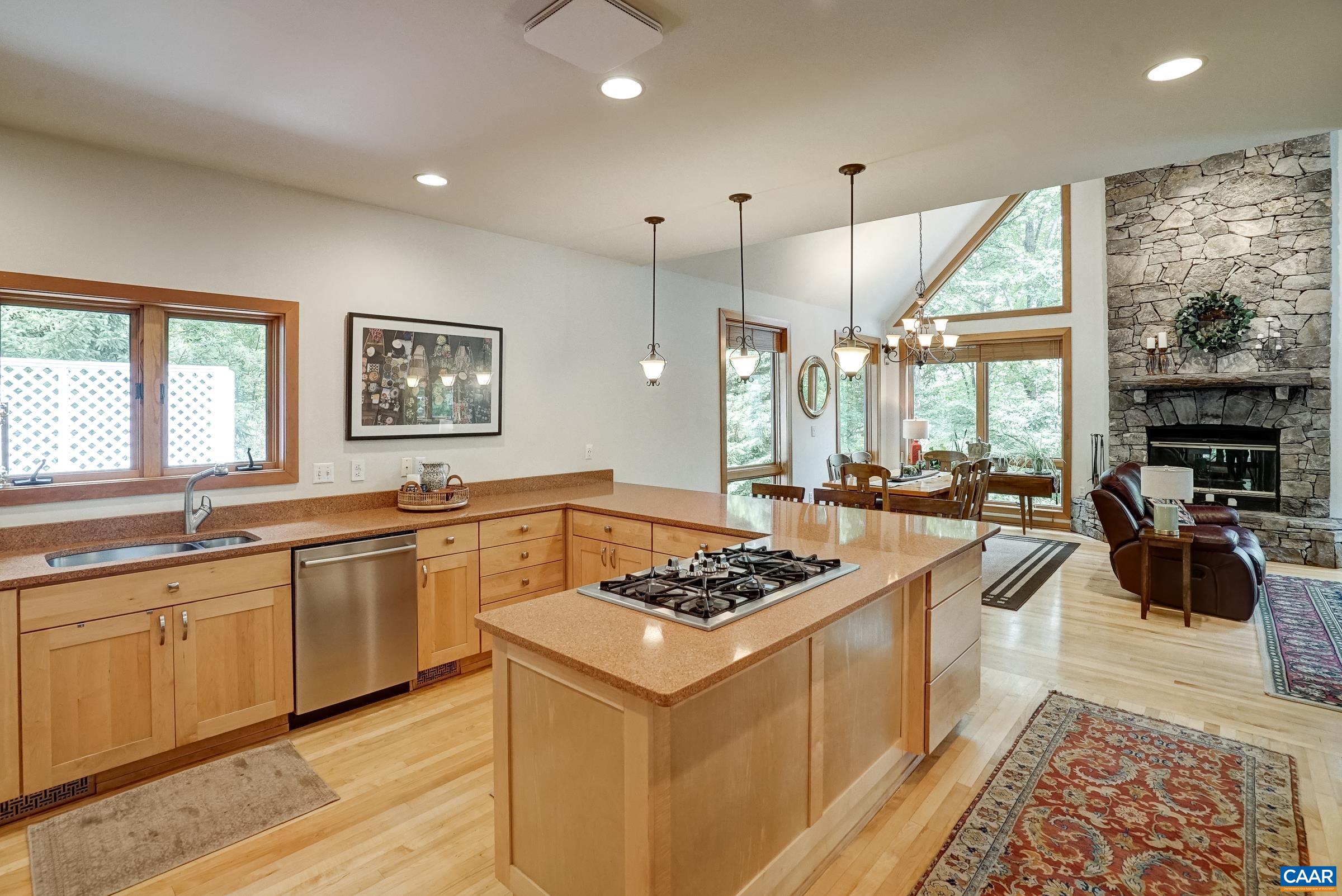 Gourmet kitchen with maple cabinets and quartz countertops.