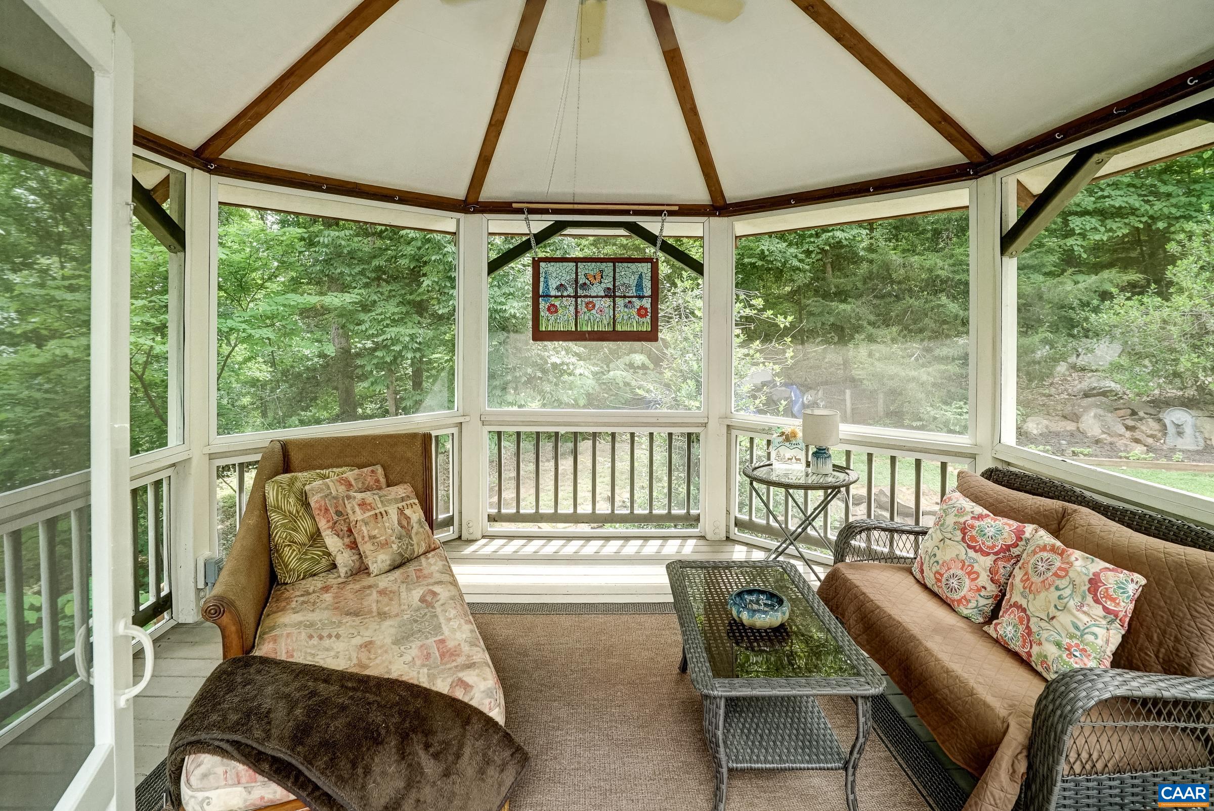 Screened gazebo keeps the bugs away and features a ceiling fan for hot days.
