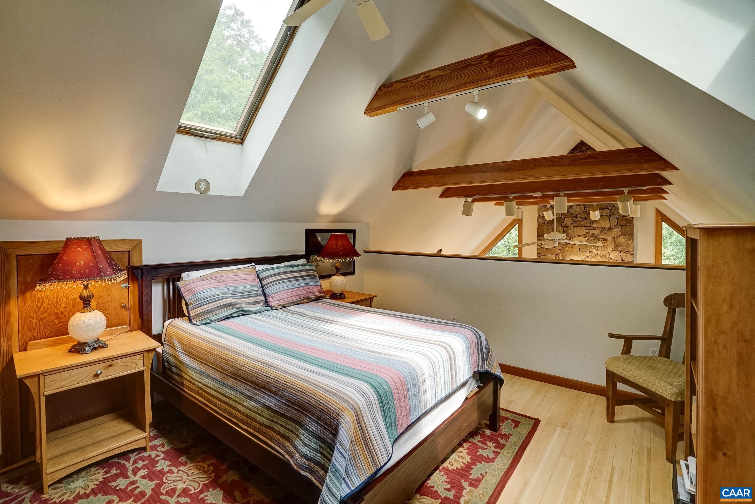 Upstairs the vaulted loft features skylights and built-in shelving.