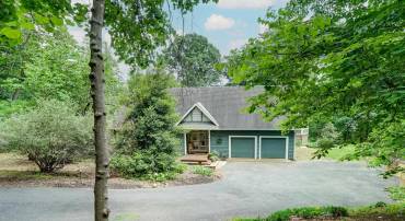 Mature woodlands surround this beautiful home with incredible mountain views from the rear decks.