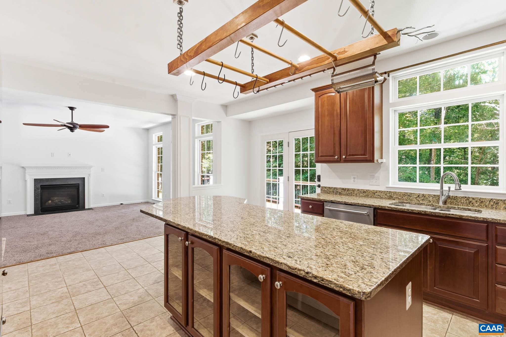 The kitchen opens into the main family room and rear outdoor living areas.