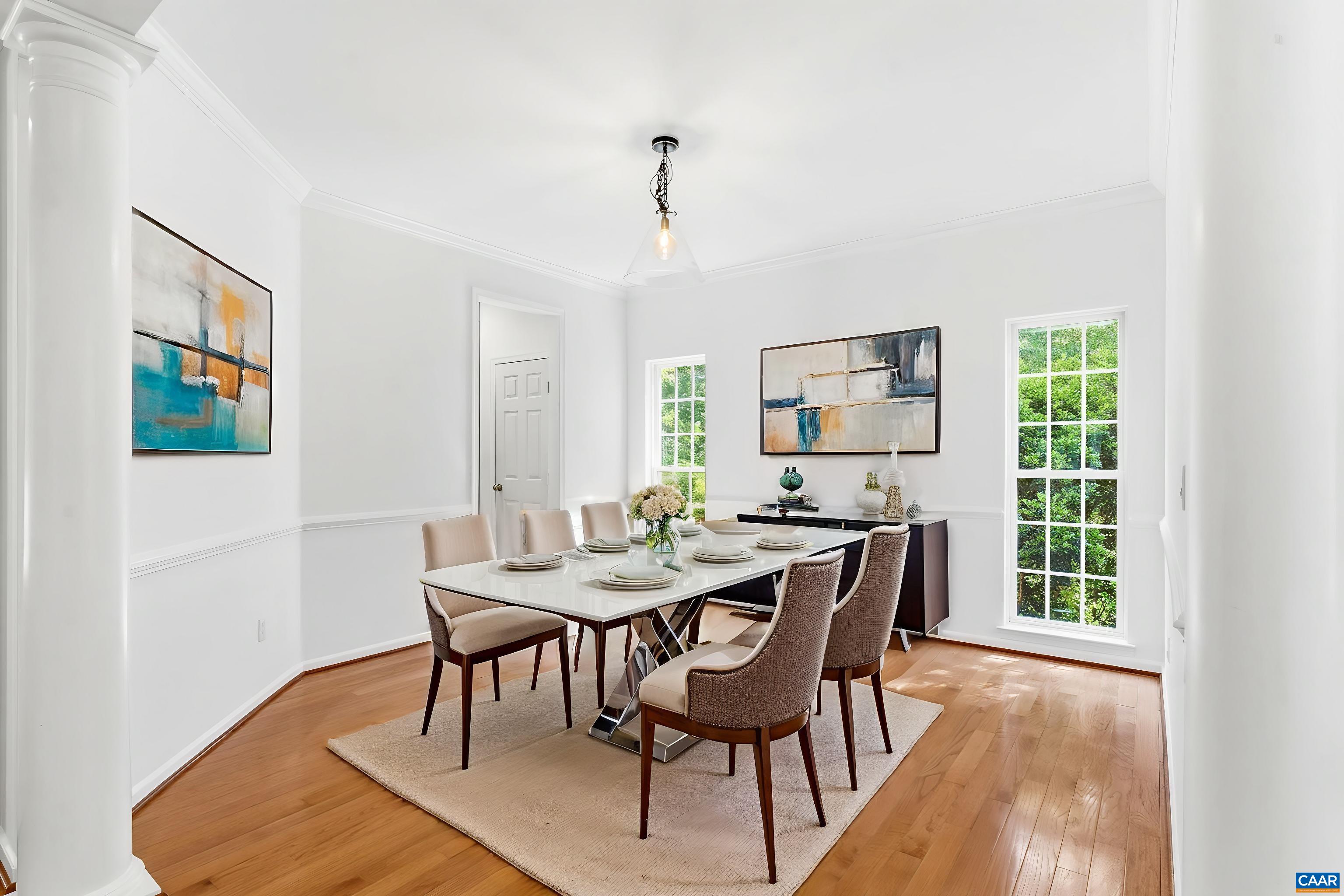 Dedicated dining space with hardwood floors, tall windows, and easy access to the kitchen, ready to entertain.