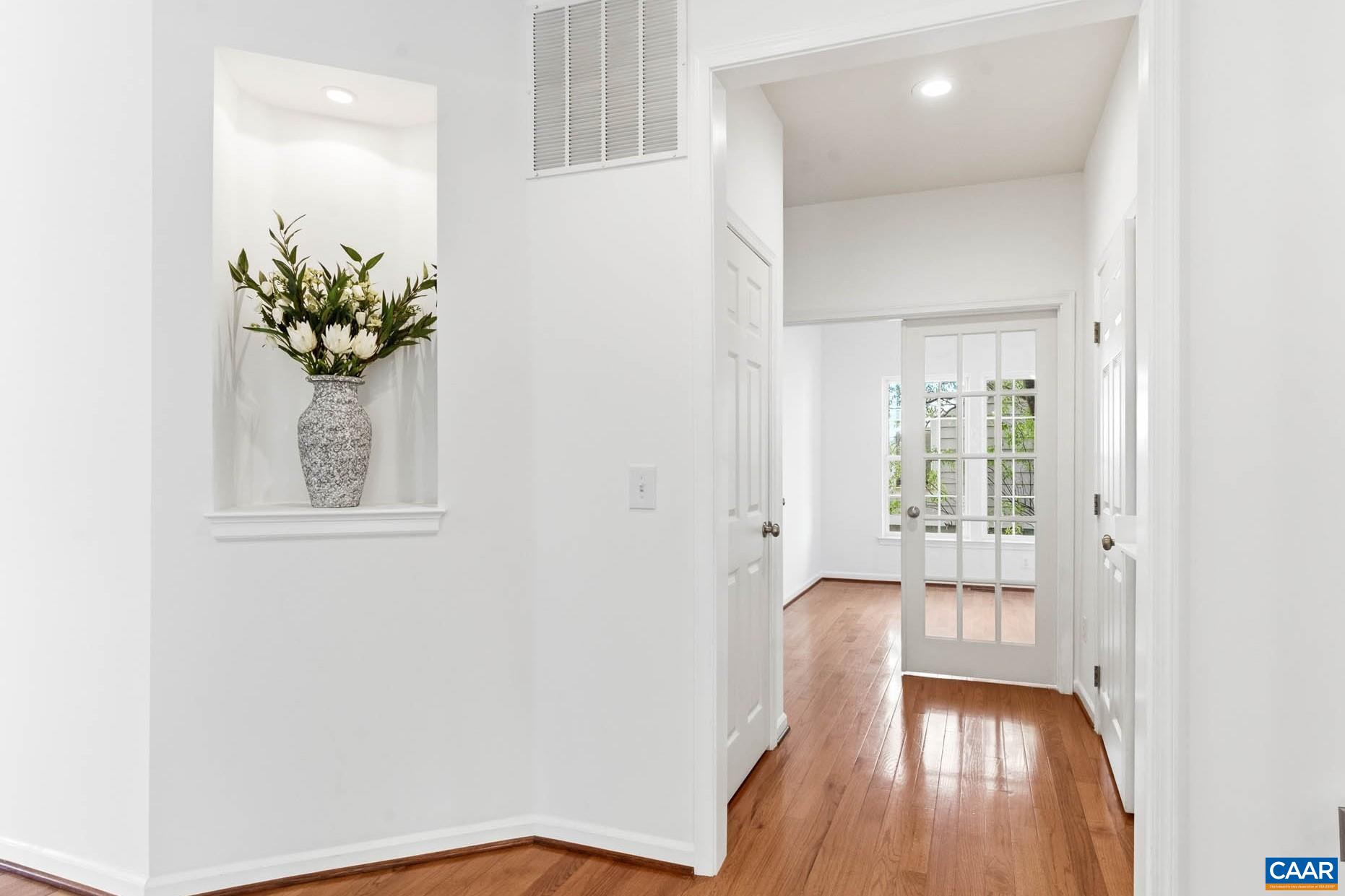 Main-level garage entry with dedicated office/flex space and half bath.