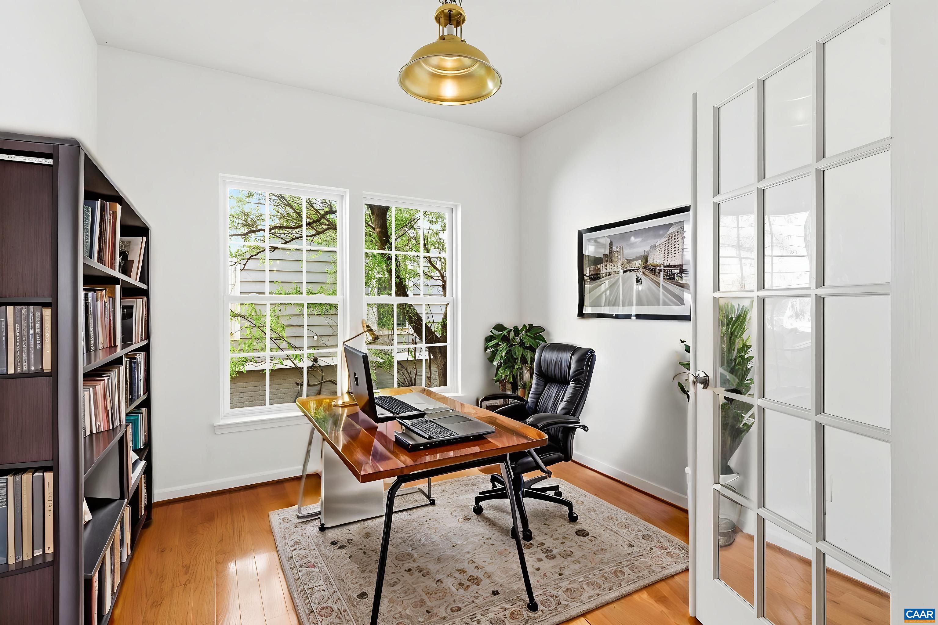 Private office space with hardwood floors and natural light, ideal for remote work or study. Virtually Staged.
