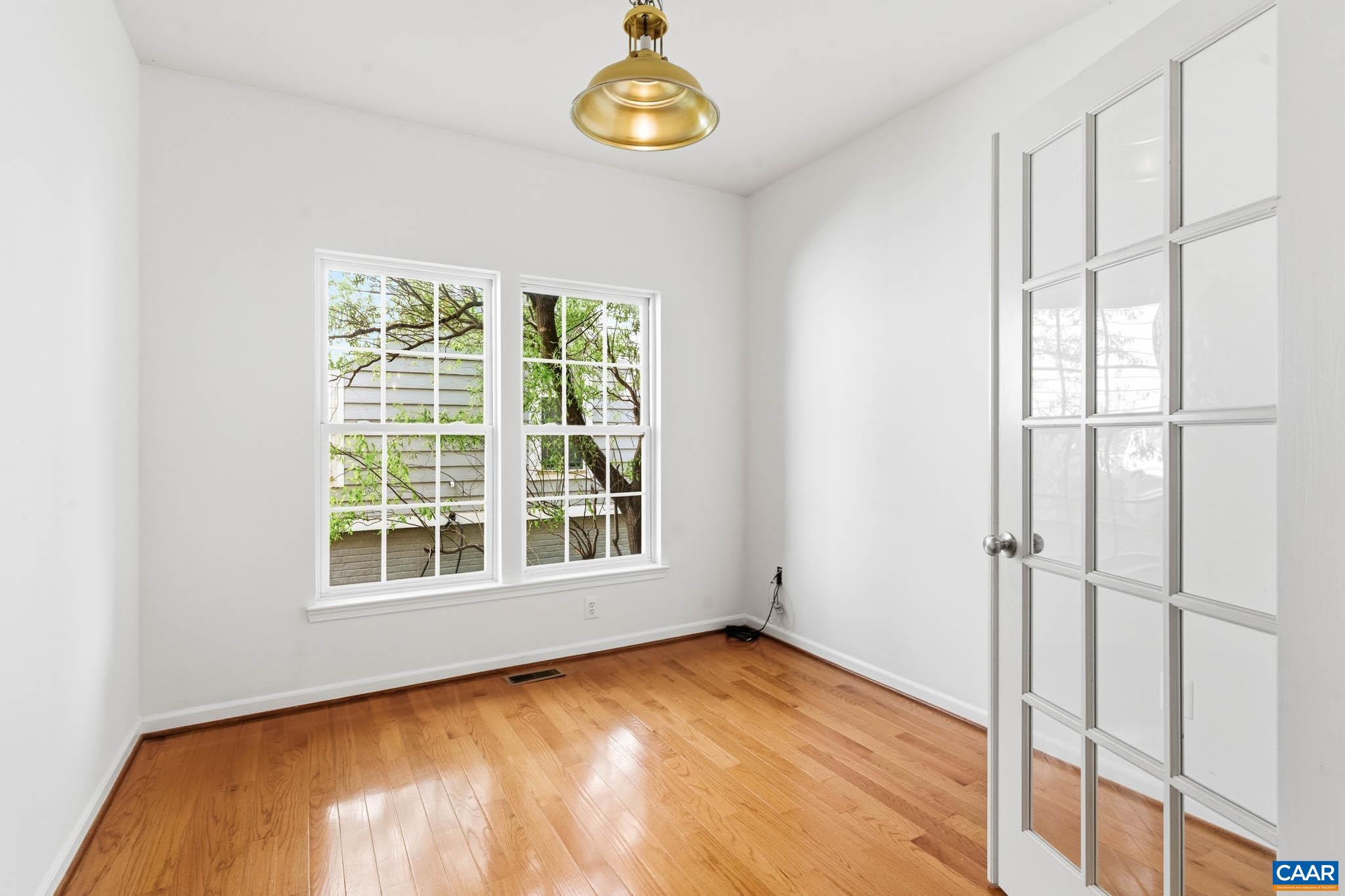 Private office space with hardwood floors and natural light, ideal for remote work or study.