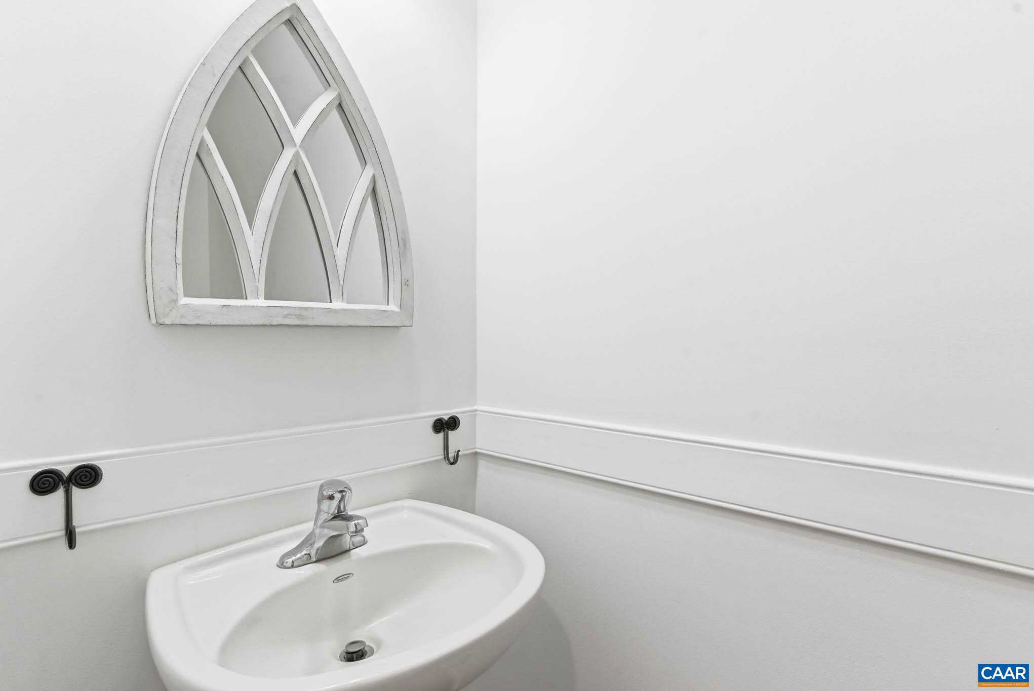 Convenient powder room serving the main living areas.