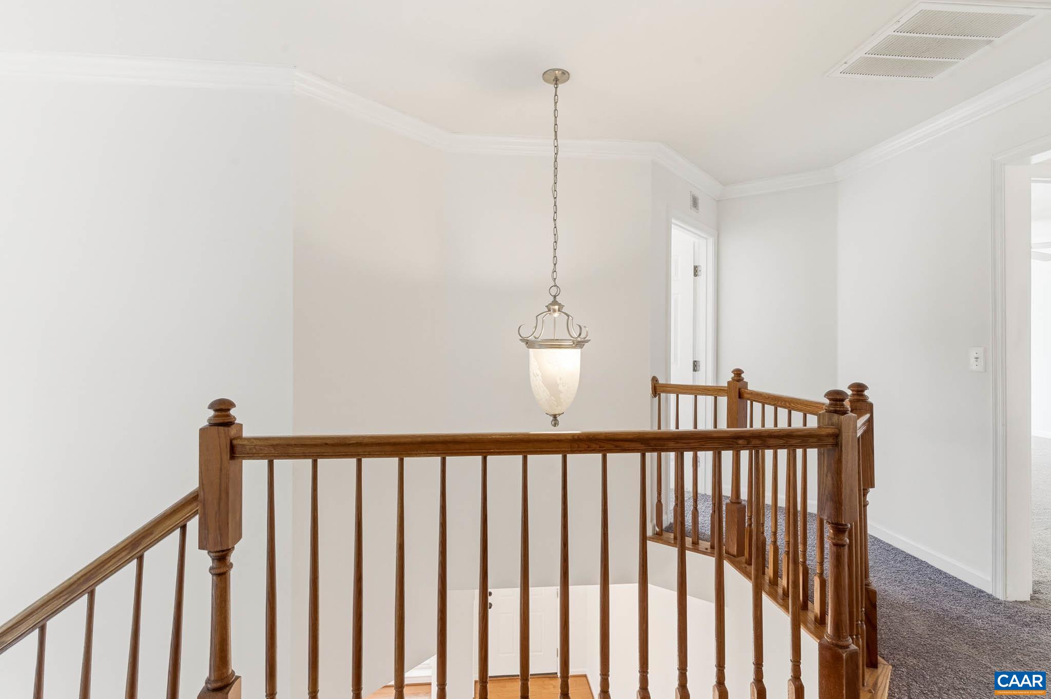 Transition to the bedroom level with hall connection and open vertical feel.