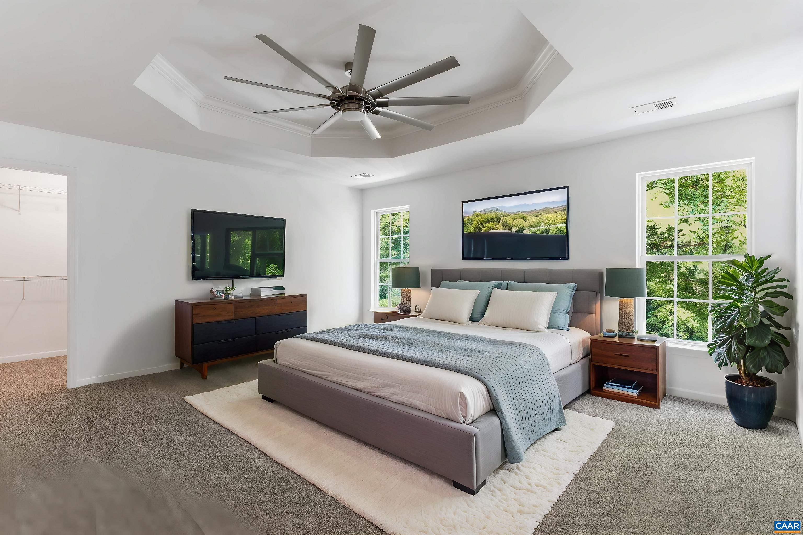 Spacious primary bedroom with tall windows, natural light, and room for a full bedroom setup with spacious walk in closet. Virtually Staged.