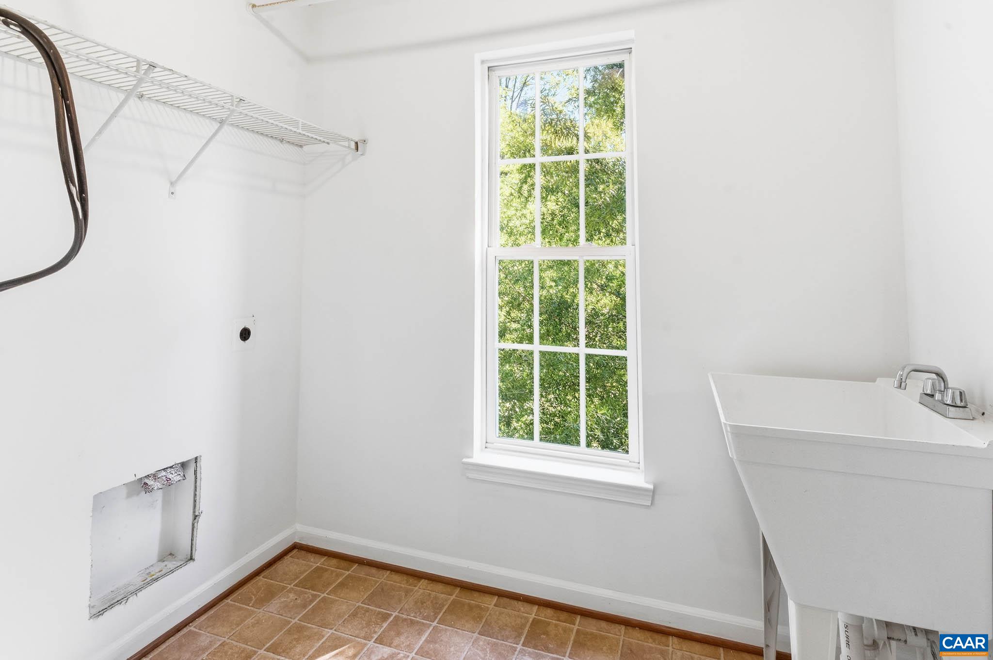 Large laundry room with sink and attic access.