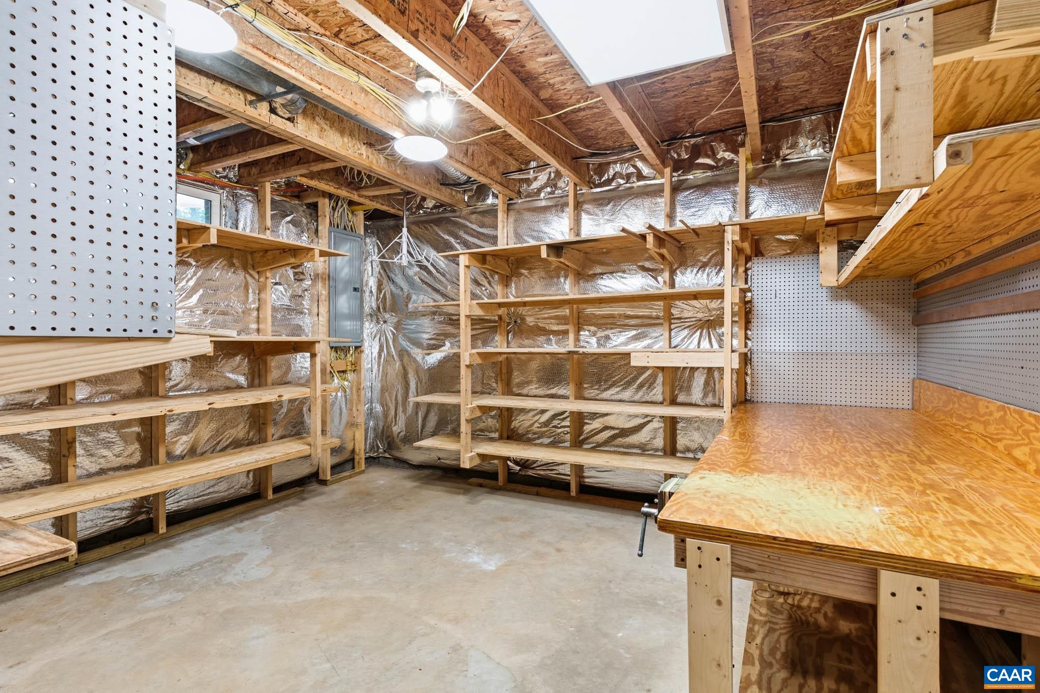 Terrace level flex space with built-in shelving perfect for storage or a workshop.