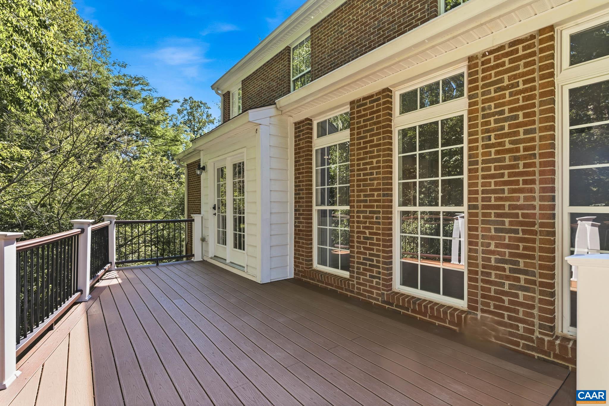 Large, peaceful, elevated deck directly off the kitchen/family room, overlooking mature trees.