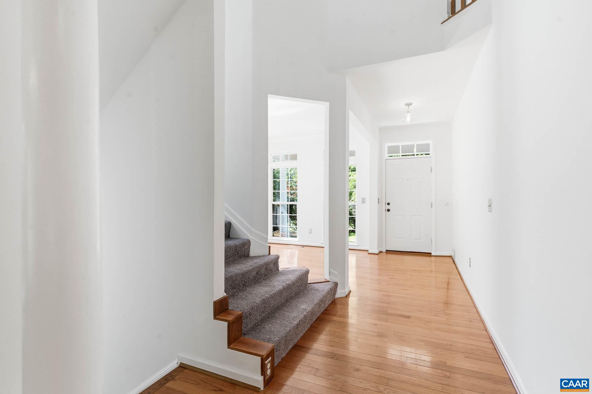 The foyer connects the front entry, staircase, and main-level living spaces.
