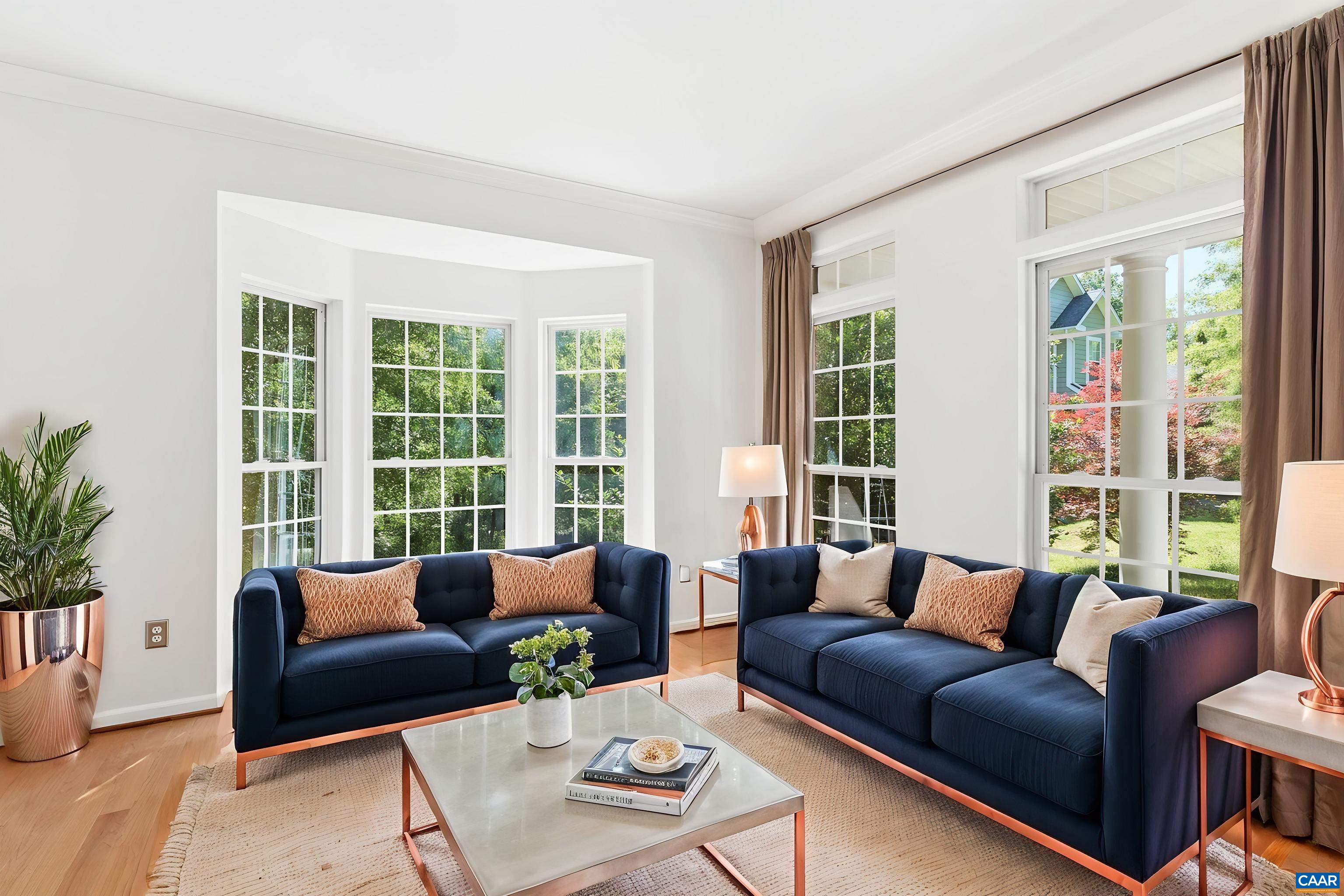 Bright front living space with hardwood floors and tall windows. Virtually Staged.