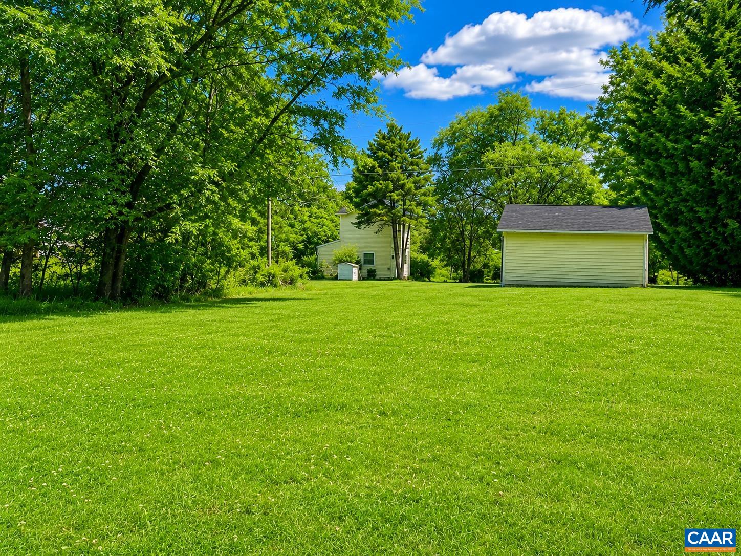 The view of the rear of the backyard looking towards the house.