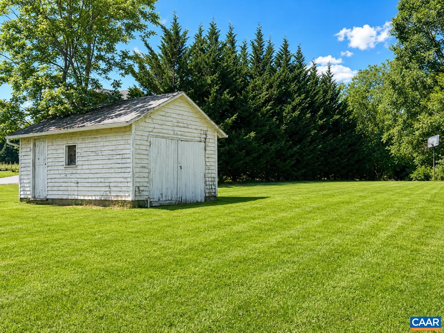 This shed is at the edge of the property, near the driveway.