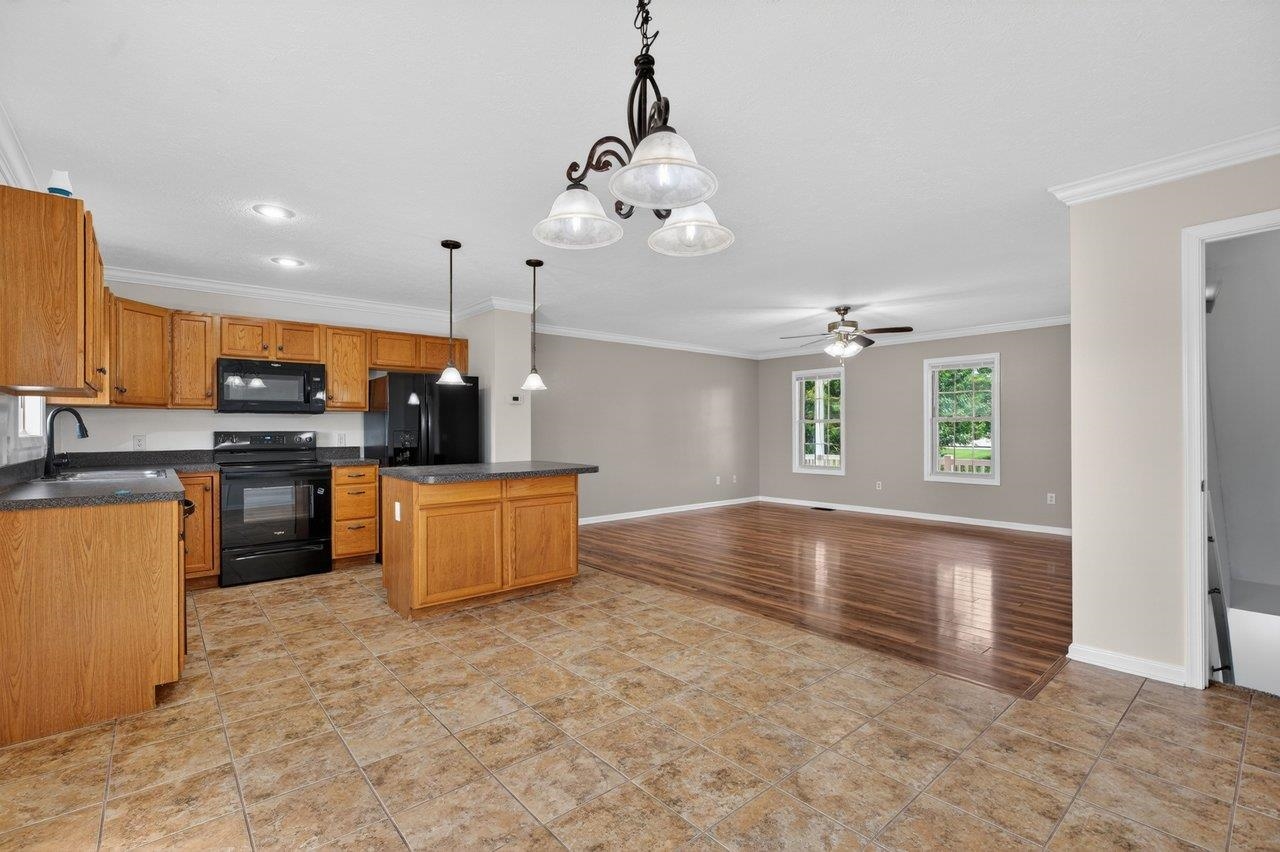 Oak cabinets, island, Formica counter-tops and modern black appliances Oak cabinets, island, Formica counter-tops and modern black appliances