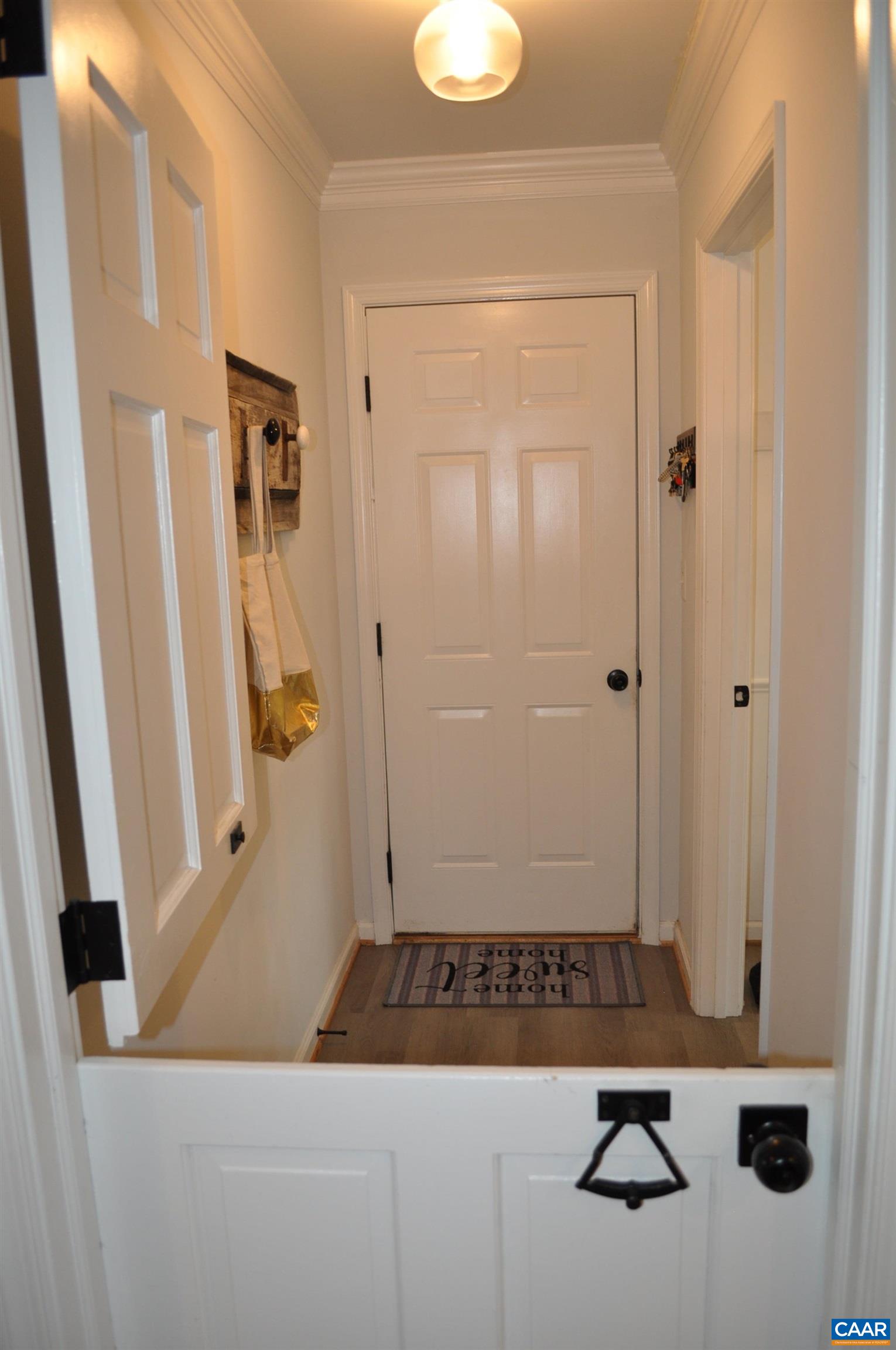 Hallway to garage and laundry with split barn-style door Hallway to garage and laundry with split barn-style door