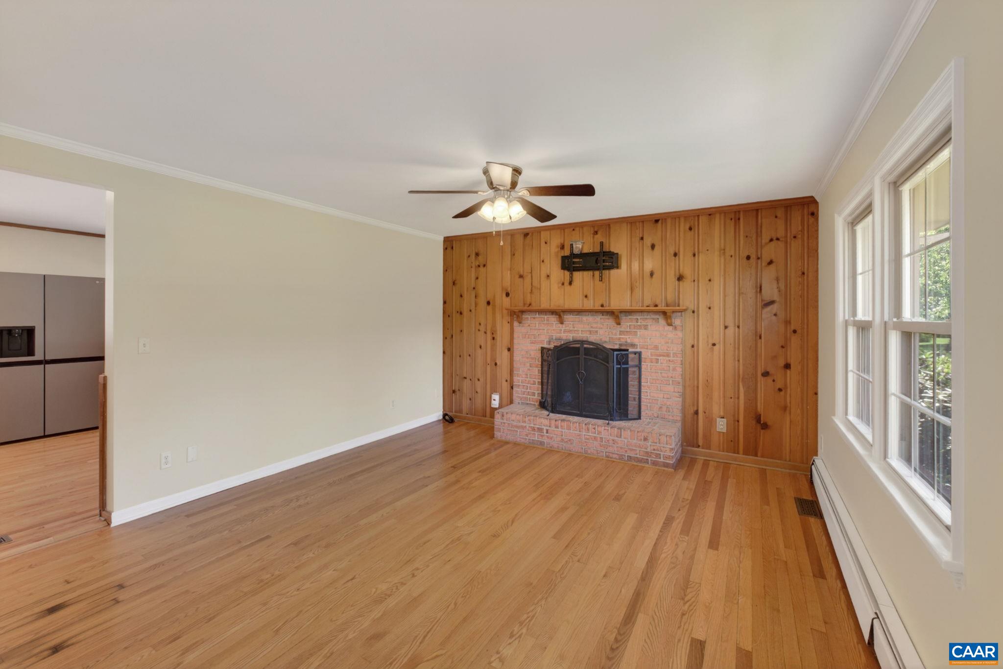 Large living room with wood burning fireplace.