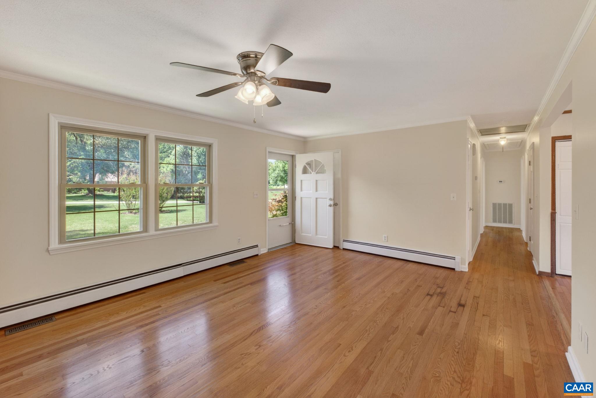 Living room, front door and hallway with basement access.