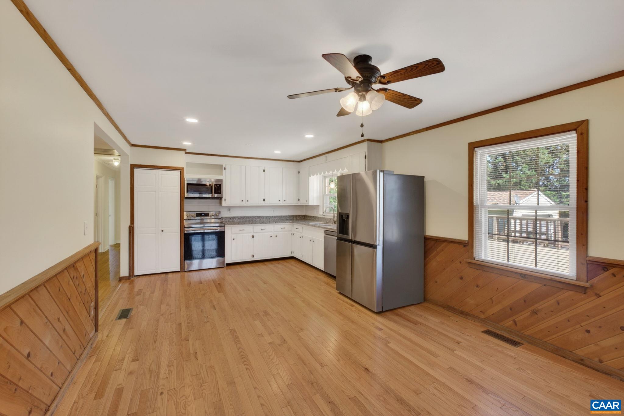 Large kitchen with stainless appliances and plenty of granite countertop.