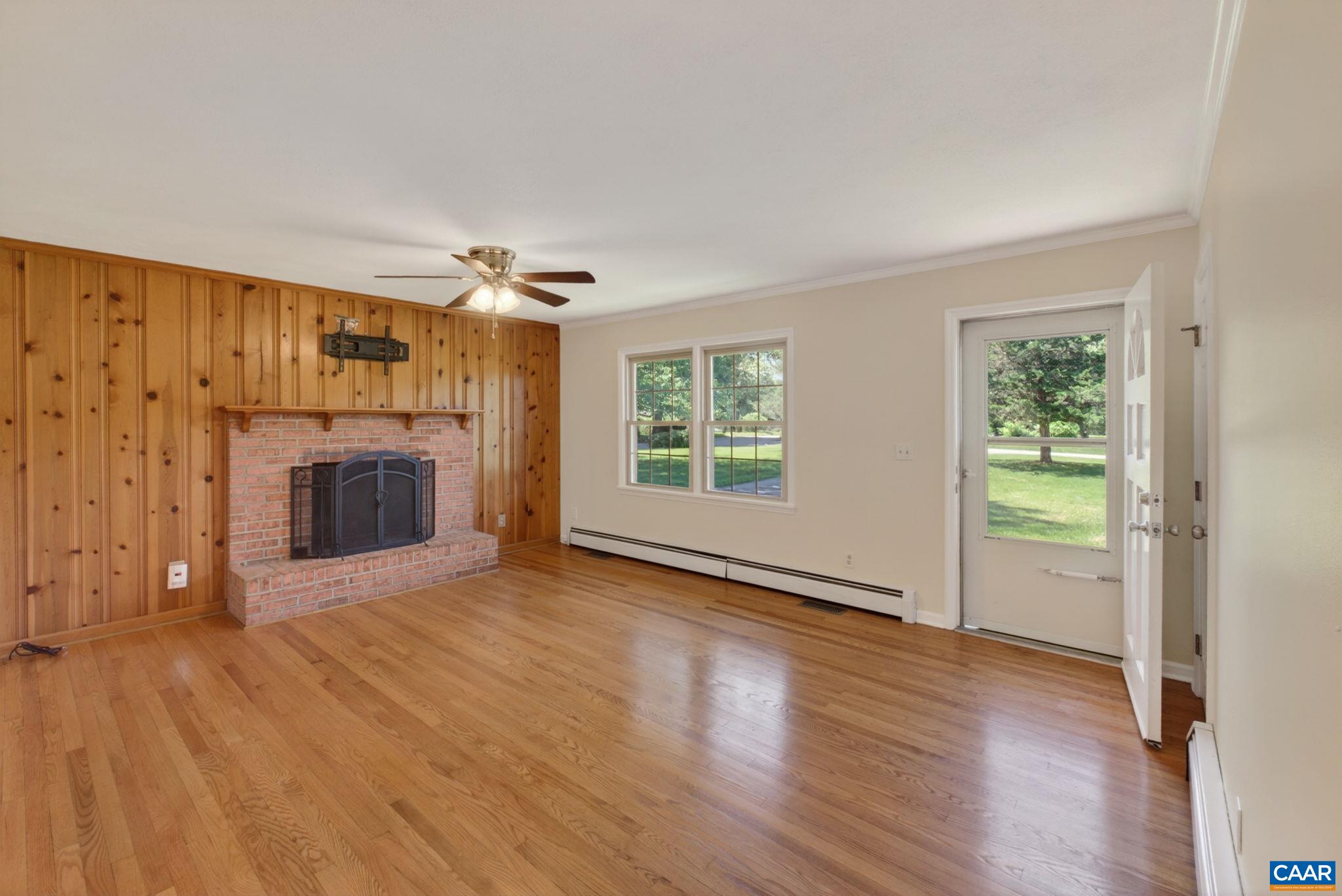 Beautiful hardwood and wood burning fireplace in the living room.