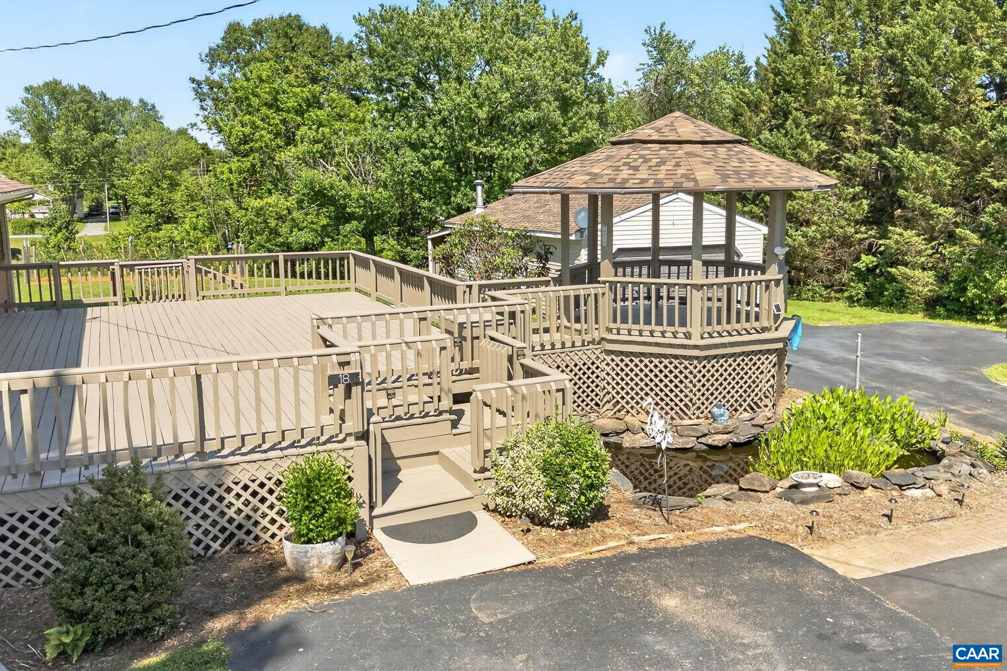 Gazebo, side deck, and fish pond with waterfall.