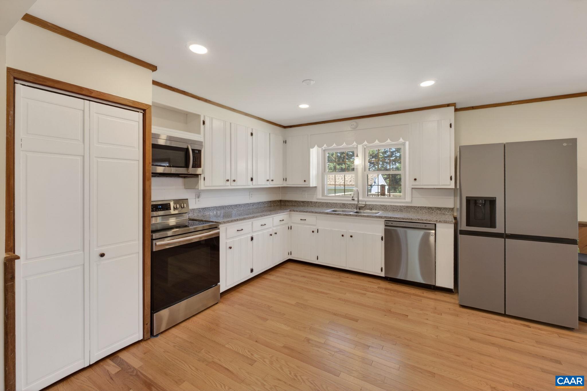 New stainless kitchen appliances and flooring.
