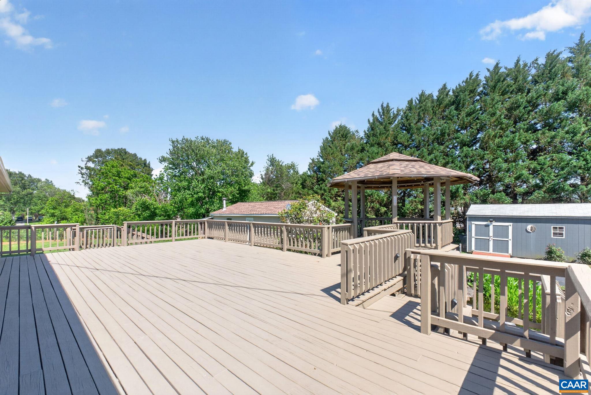 Side deck, shed at right and two car garage at left. Garage has brand new roof.
