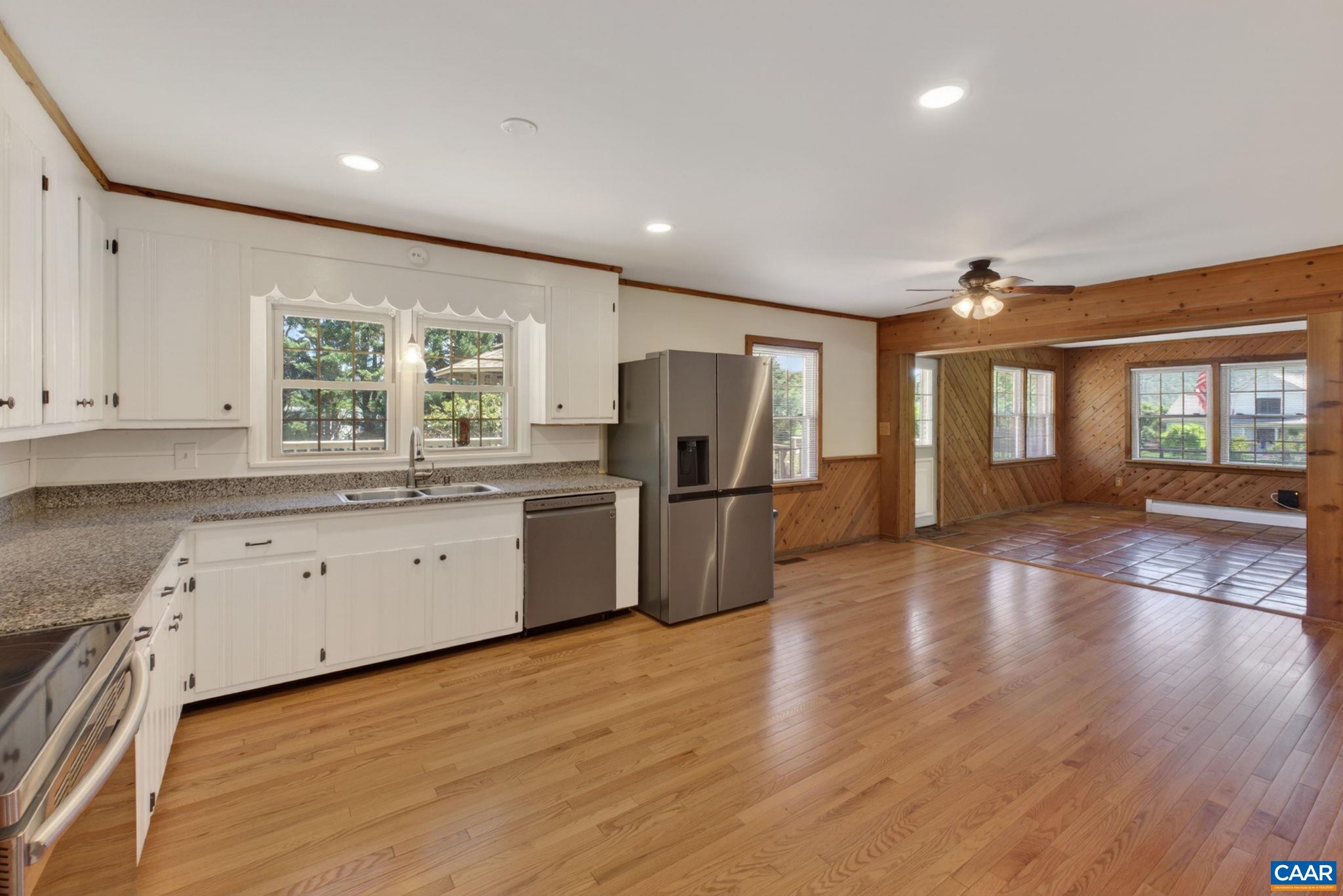Large kitchen opens into the tiled family room.