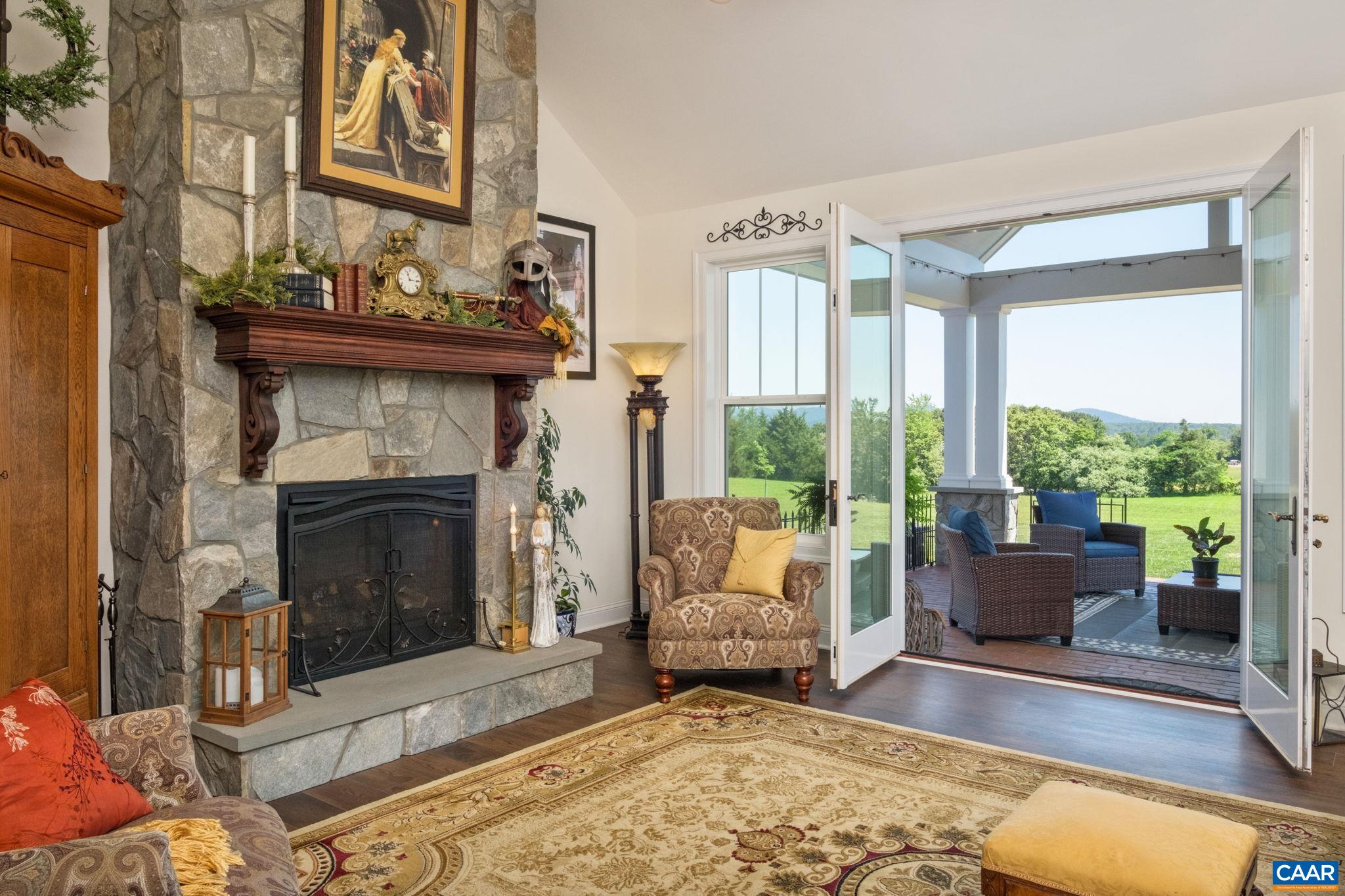 The fireplace features a rock surround and a mantel crafted by the homeowner. Stone is real stone. The fireplace features a rock surround and a mantel crafted by the homeowner. Stone is real stone.