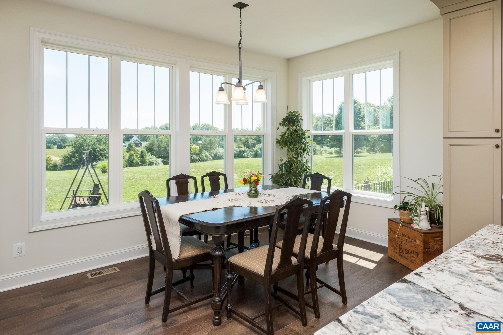 The dining room is surrounded by windows for plenty of natural light. The dining room is surrounded by windows for plenty of natural light.