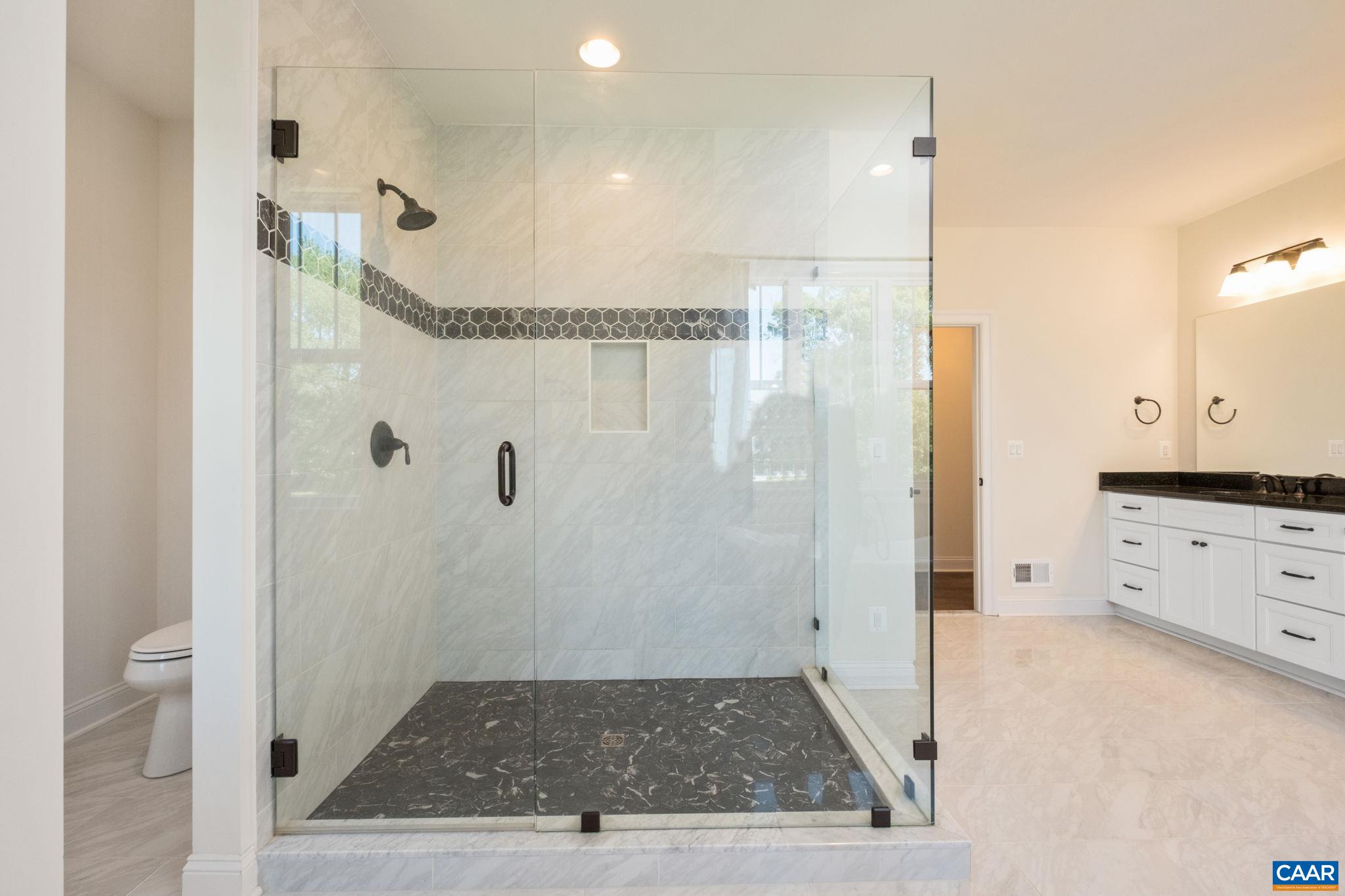 The large tiled shower is in view. The large tiled shower is in view.