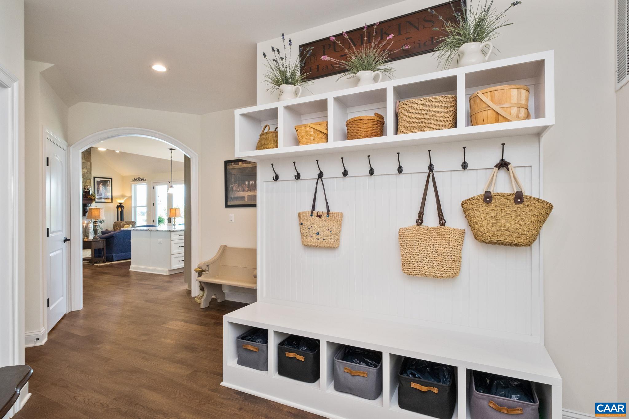 This welcome center is located in the back hallway just off of the garage. The walk-in pantry is to the left in the hallway, the half bath is to the left, the basement is to the left, and the two bedrooms with full bathroom are located to the right. This welcome center is located in the back hallway just off of the garage. The walk-in pantry is to the left in the hallway, the half bath is to the left, the basement is to the left, and the two bedrooms with full bathroom are located to the right.