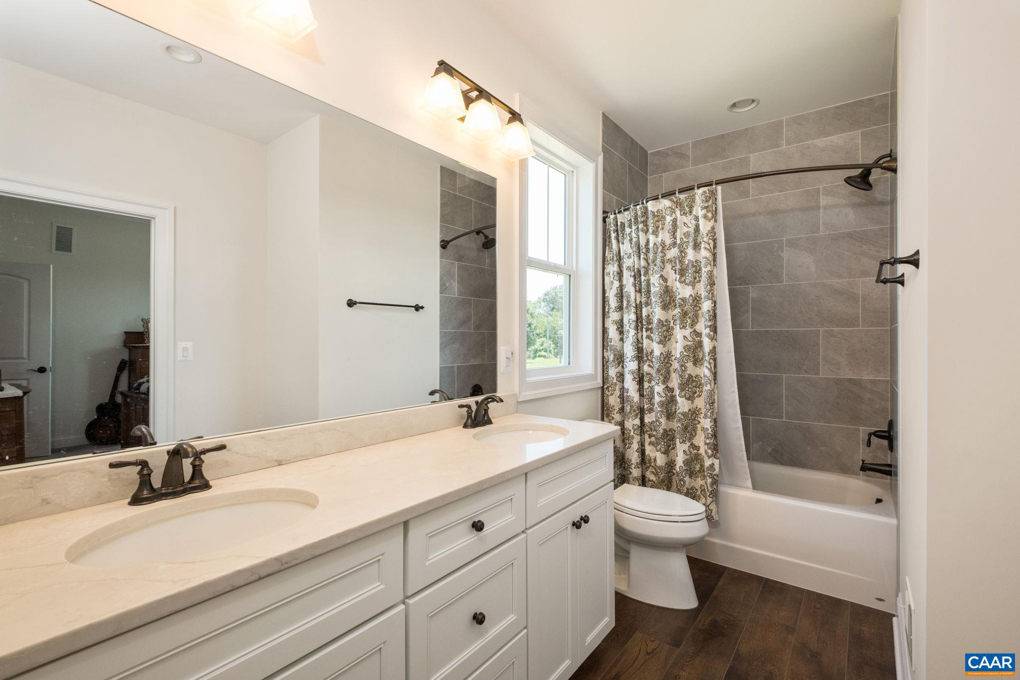 This full bathroom is located between two bedrooms on the main level, just off of the back hallway. This full bathroom is located between two bedrooms on the main level, just off of the back hallway.