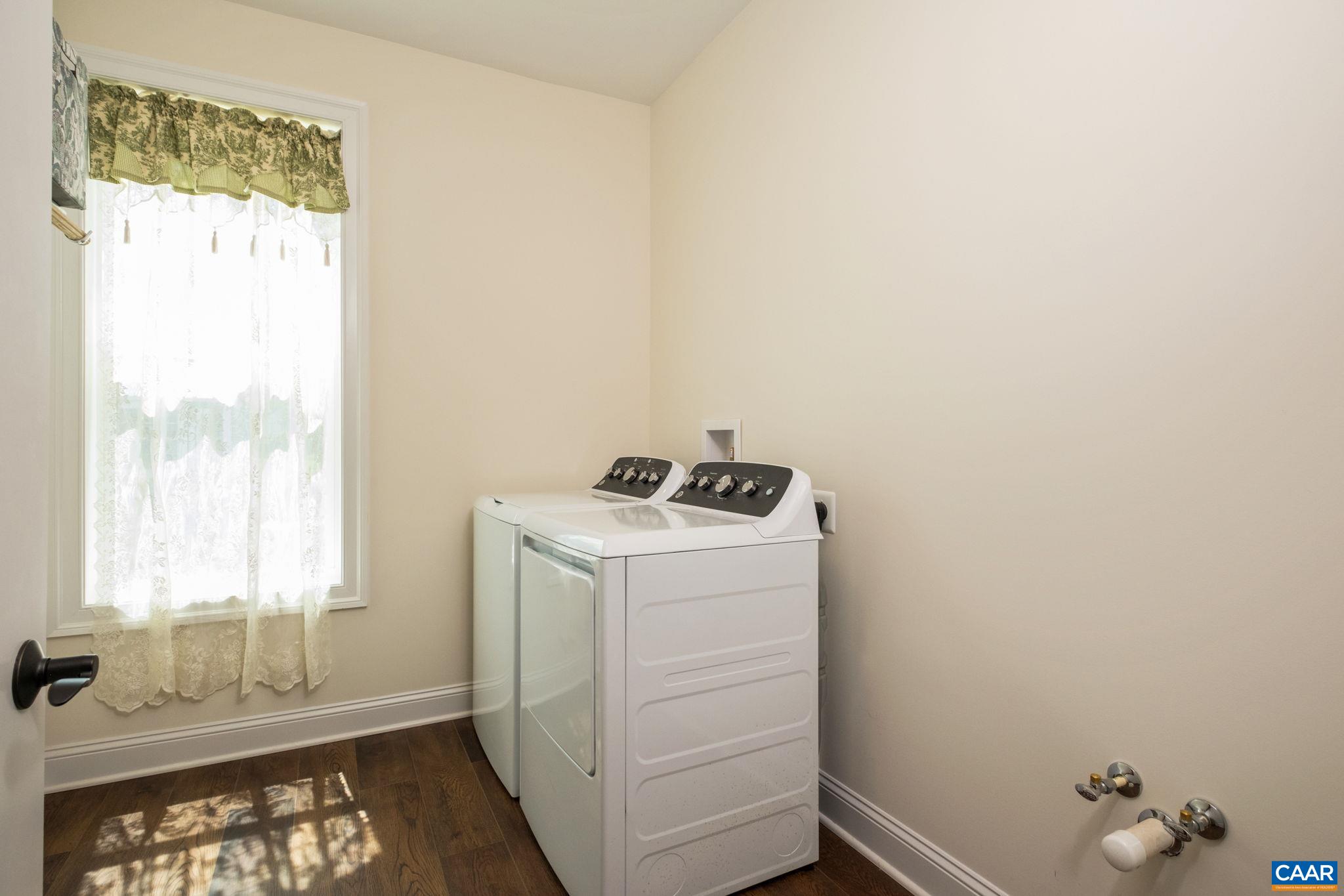 The laundry room is just off of the garage in the back hallway, and it features plenty of space, shelves, and plumbing for a laundry sink. The laundry room is just off of the garage in the back hallway, and it features plenty of space, shelves, and plumbing for a laundry sink.