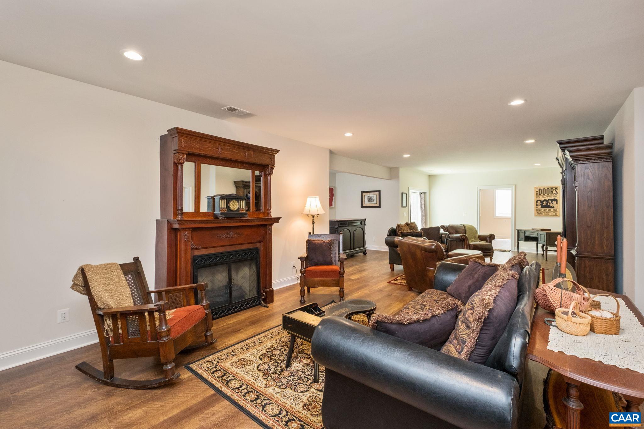 This space is the living room/den area in the basement. This portion of the living room/den has an electric fireplace, and a fireplace surround from a 100-year old home. This space is the living room/den area in the basement. This portion of the living room/den has an electric fireplace, and a fireplace surround from a 100-year old home.