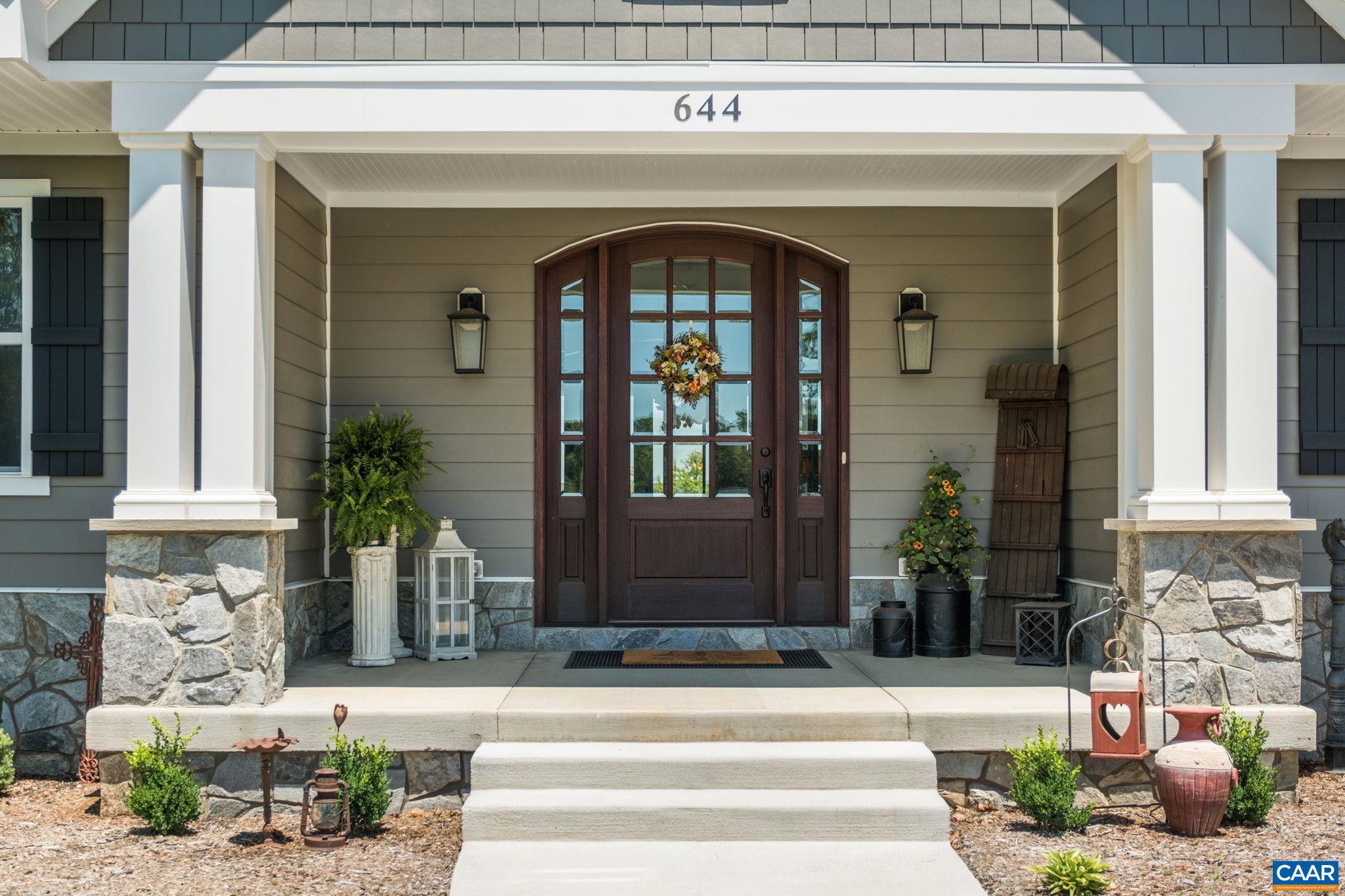Pillars with real stone, and the front door is solid wood with mahogany stain. Pillars with real stone, and the front door is solid wood with mahogany stain.