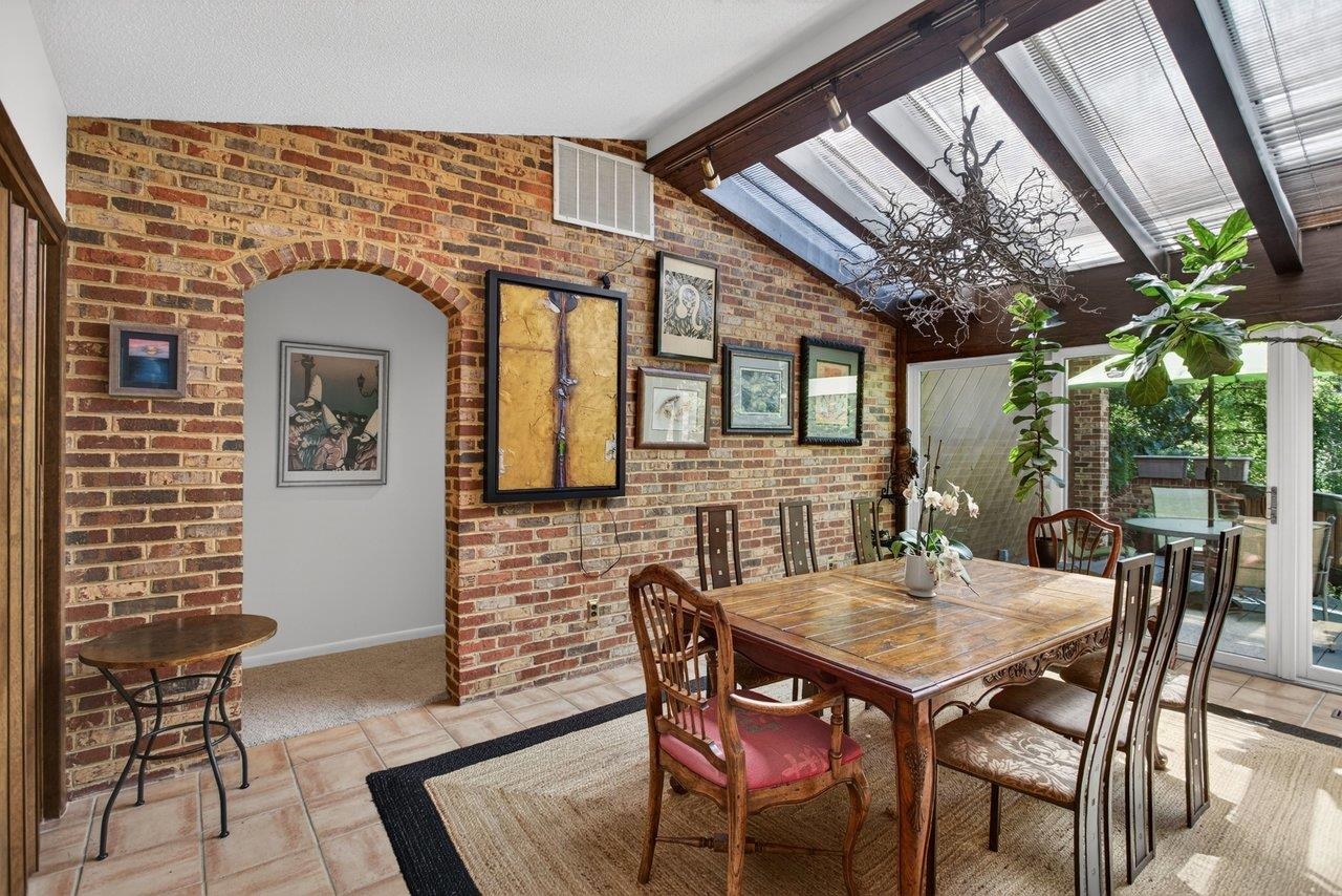 This room is right off the kitchen and features a heated brick floor, skylights and doors out to a deck overlooking the pool and backyard This room is right off the kitchen and features a heated brick floor, skylights and doors out to a deck overlooking the pool and backyard