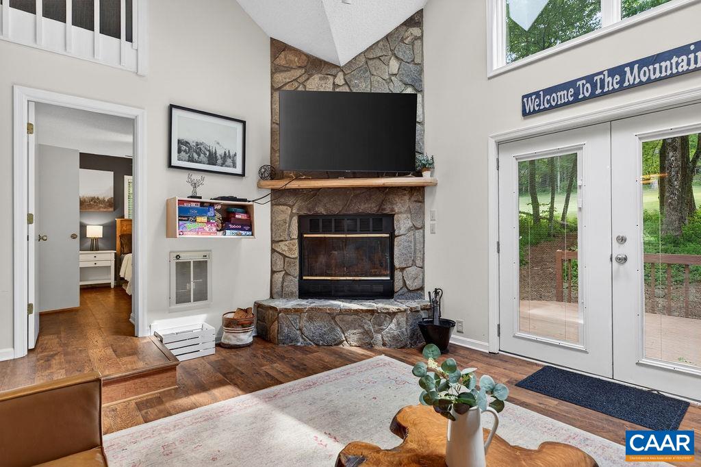 A stone, wood-burning fireplace serves as the focal point of the open living area. A stone, wood-burning fireplace serves as the focal point of the open living area.