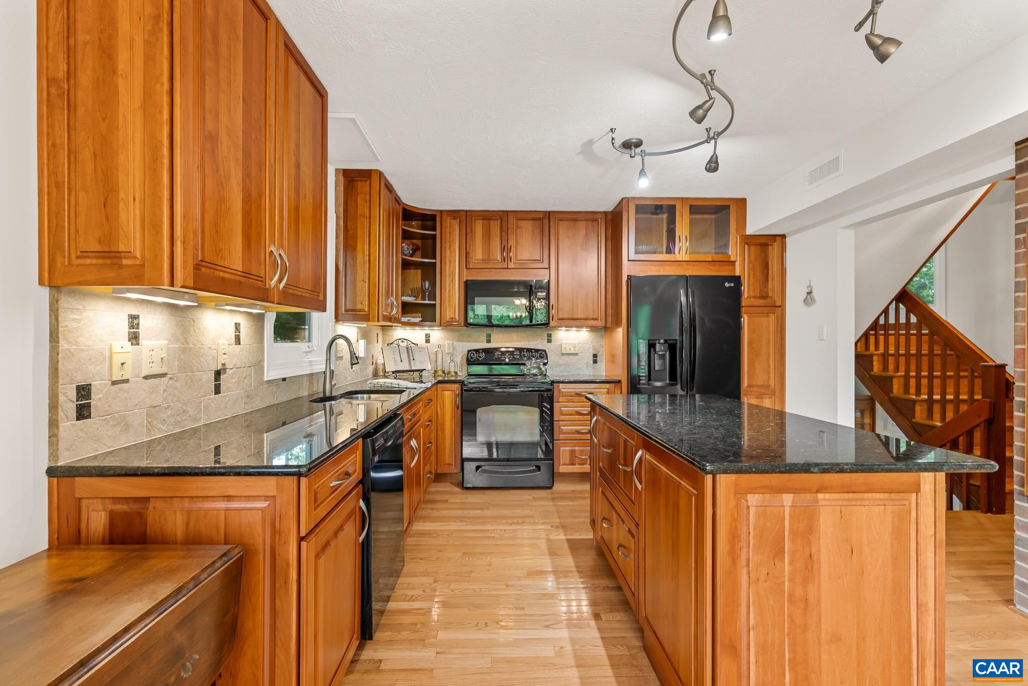 The kitchen has walls lined with custom made cherry cabinetry specifically crafted for the home. The kitchen has walls lined with custom made cherry cabinetry specifically crafted for the home.